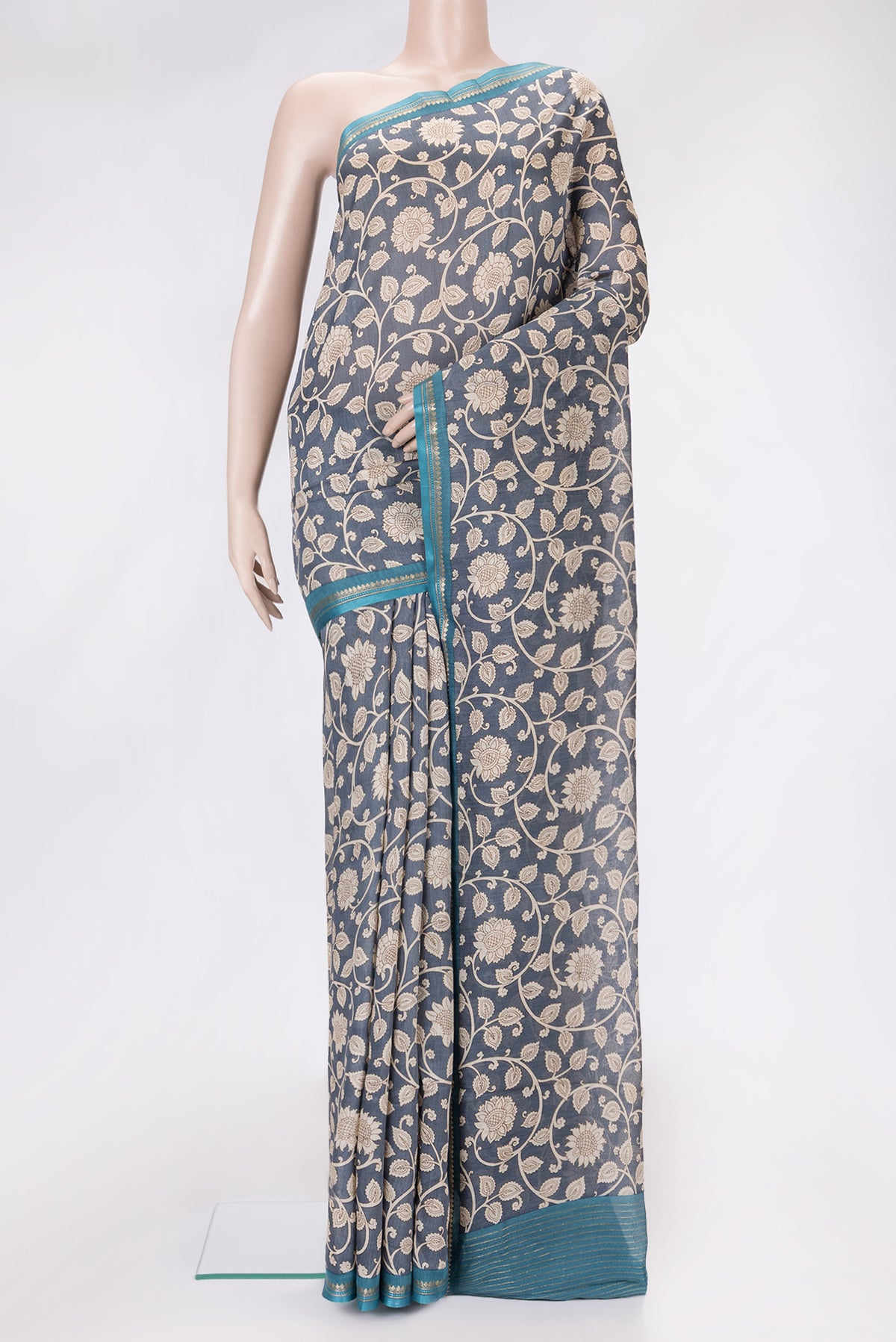 Grey Dual Tone Tussar Silk Saree with Printed design on the body and Zari And Thread Border.  displayed on a mannequin