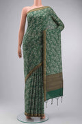 Green Tussar Silk Saree with Printed design on the body and Zari Border displayed on a mannequin