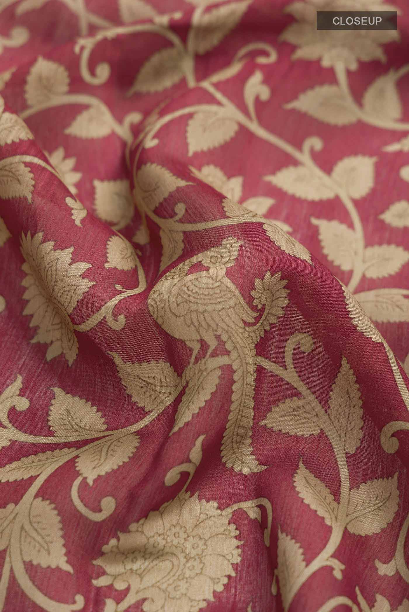 Close up of Rust Tussar Silk Saree with Printed design on the body and Zari Border displaying folds