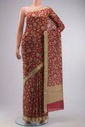 Rust Tussar Silk Saree with Printed design on the body and Zari Border displayed on a mannequin