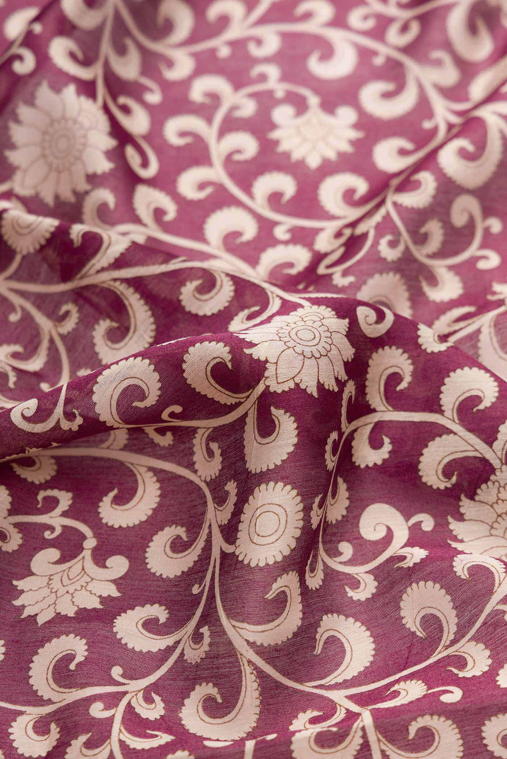 Close up of Burgundy Dual Tone Tussar Silk Saree with Printed design on the body and Zari Border displaying folds
