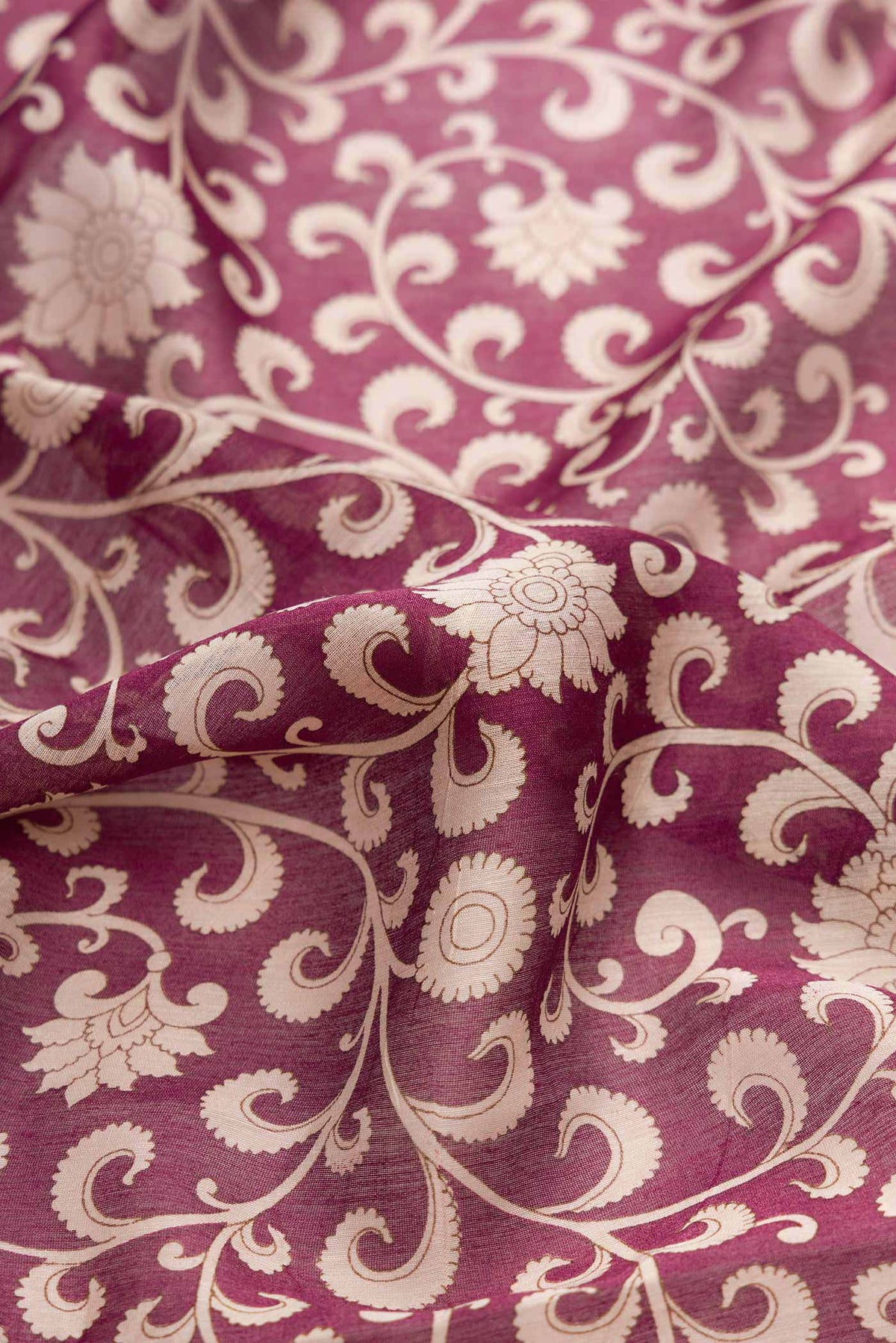 Close up of Burgundy Dual Tone Tussar Silk Saree with Printed design on the body and Zari Border displaying folds