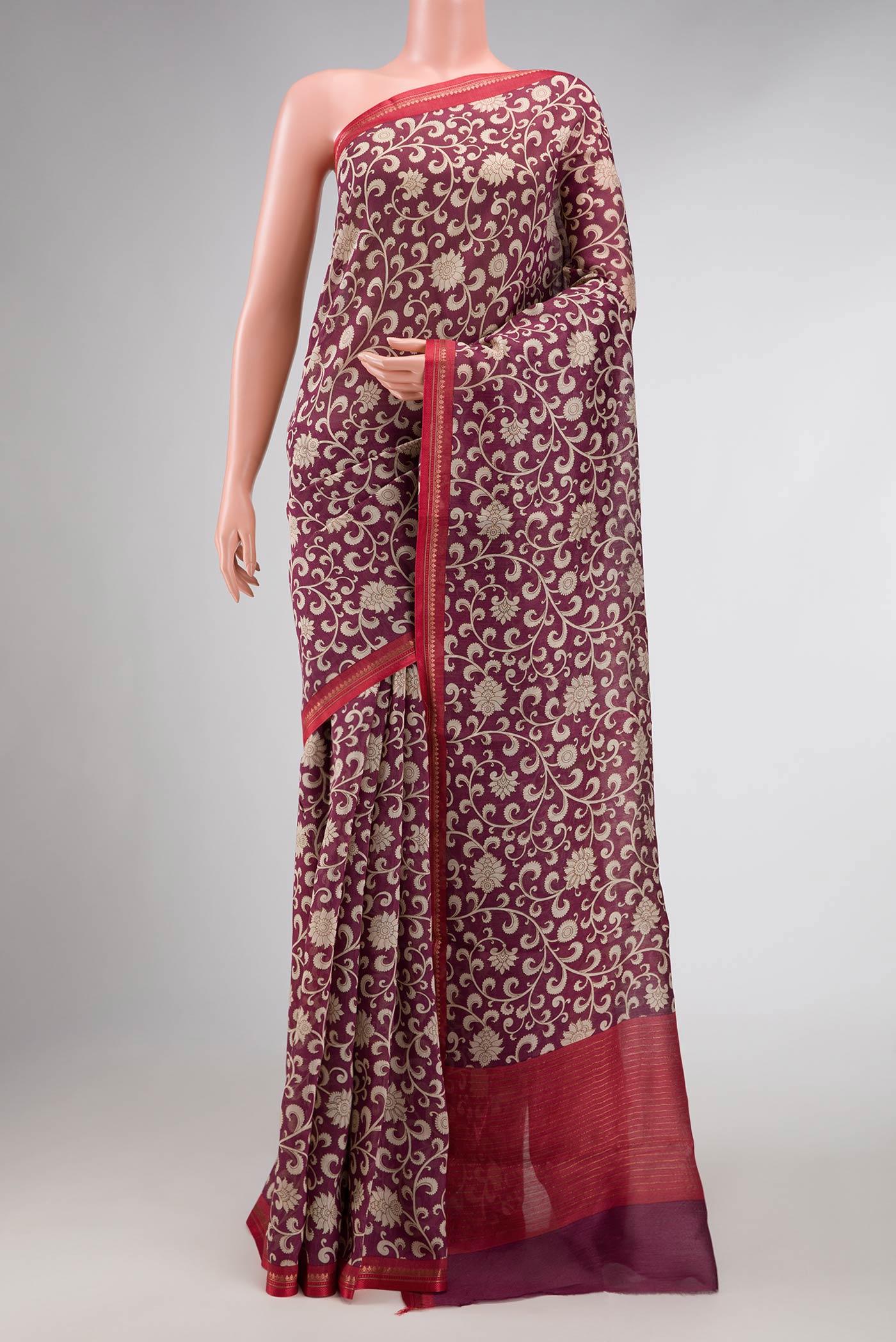 Burgundy Dual Tone Tussar Silk Saree with Printed design on the body and Zari Border displayed on a mannequin