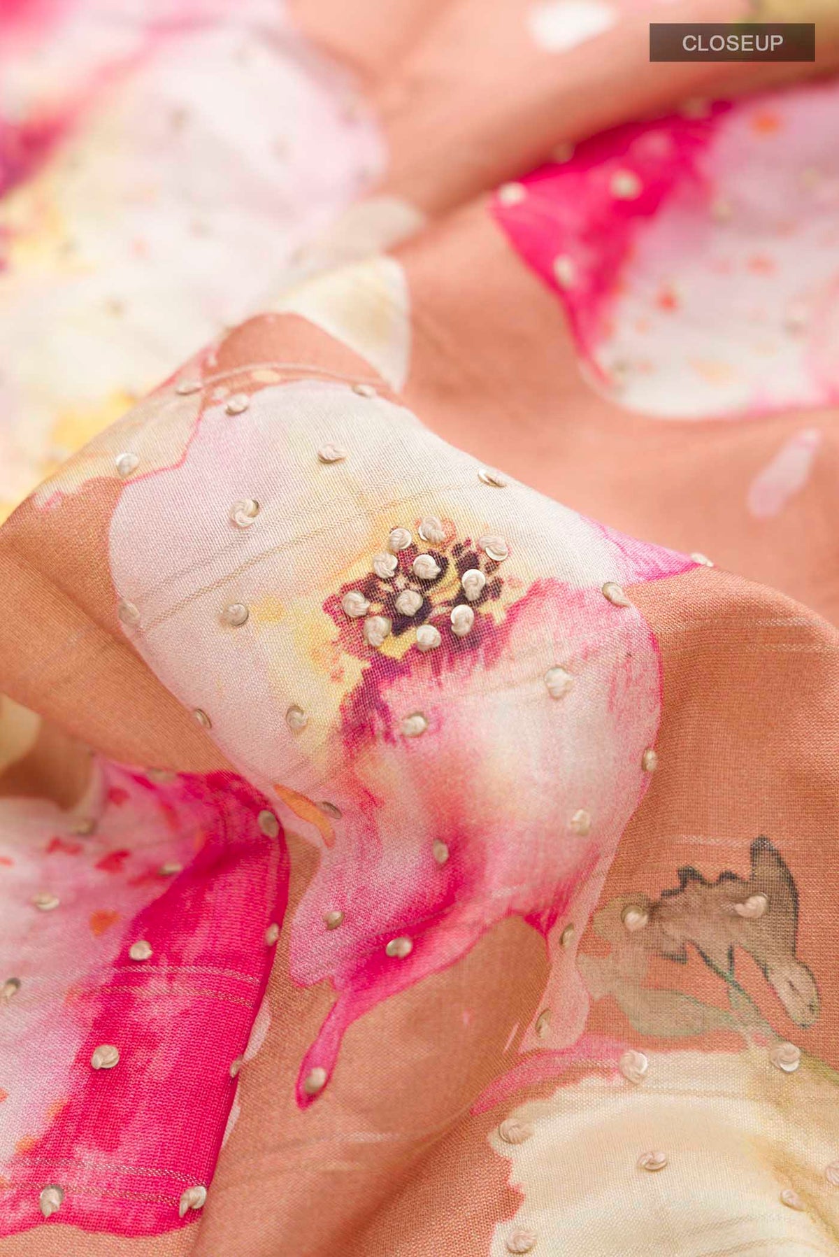 Close up of Brown Tussar Silk Saree with Embroidery on the body and Zari Border displaying folds