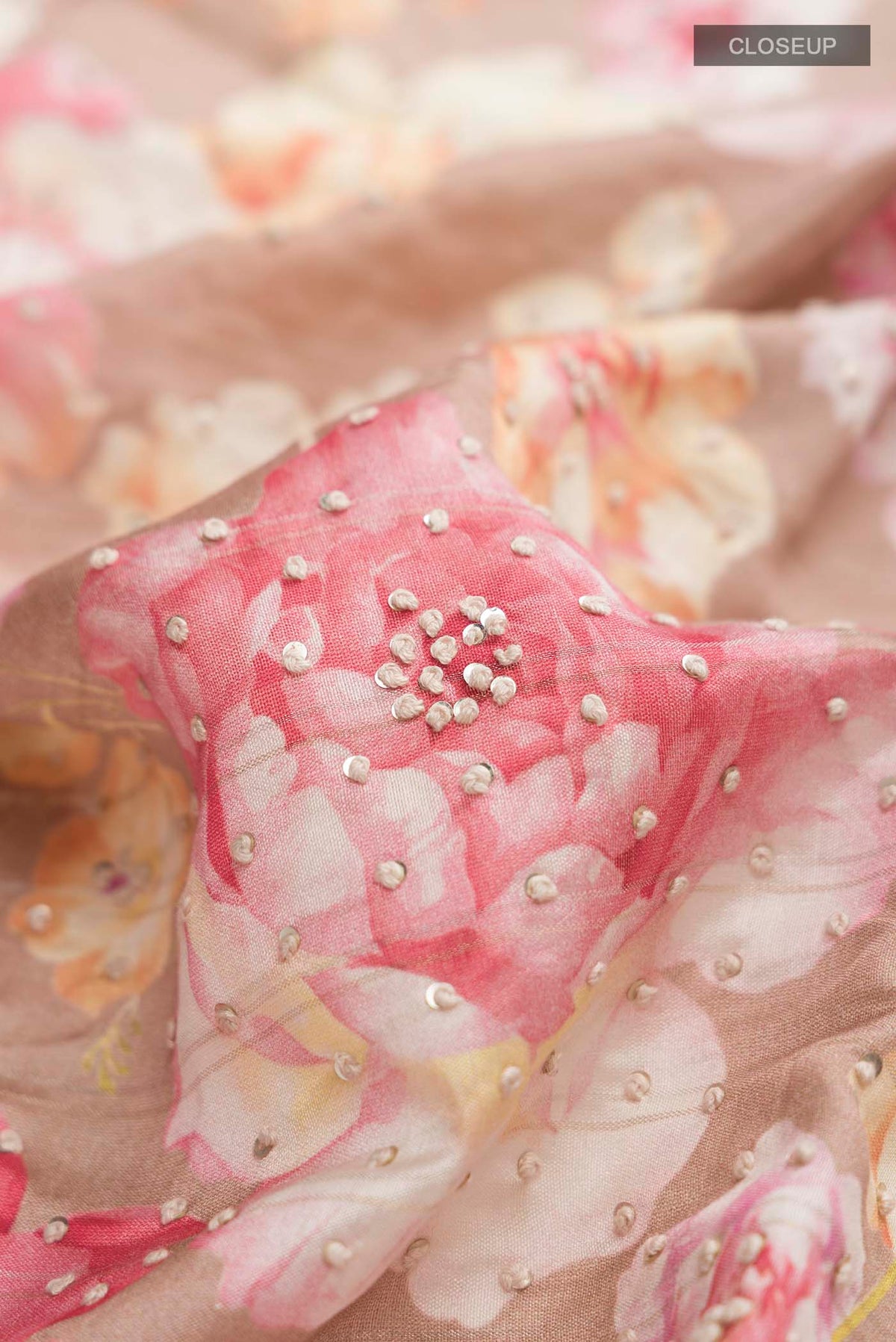 Close up of Brown Tussar Silk Saree with Printed design on the body and Zari Border displaying folds