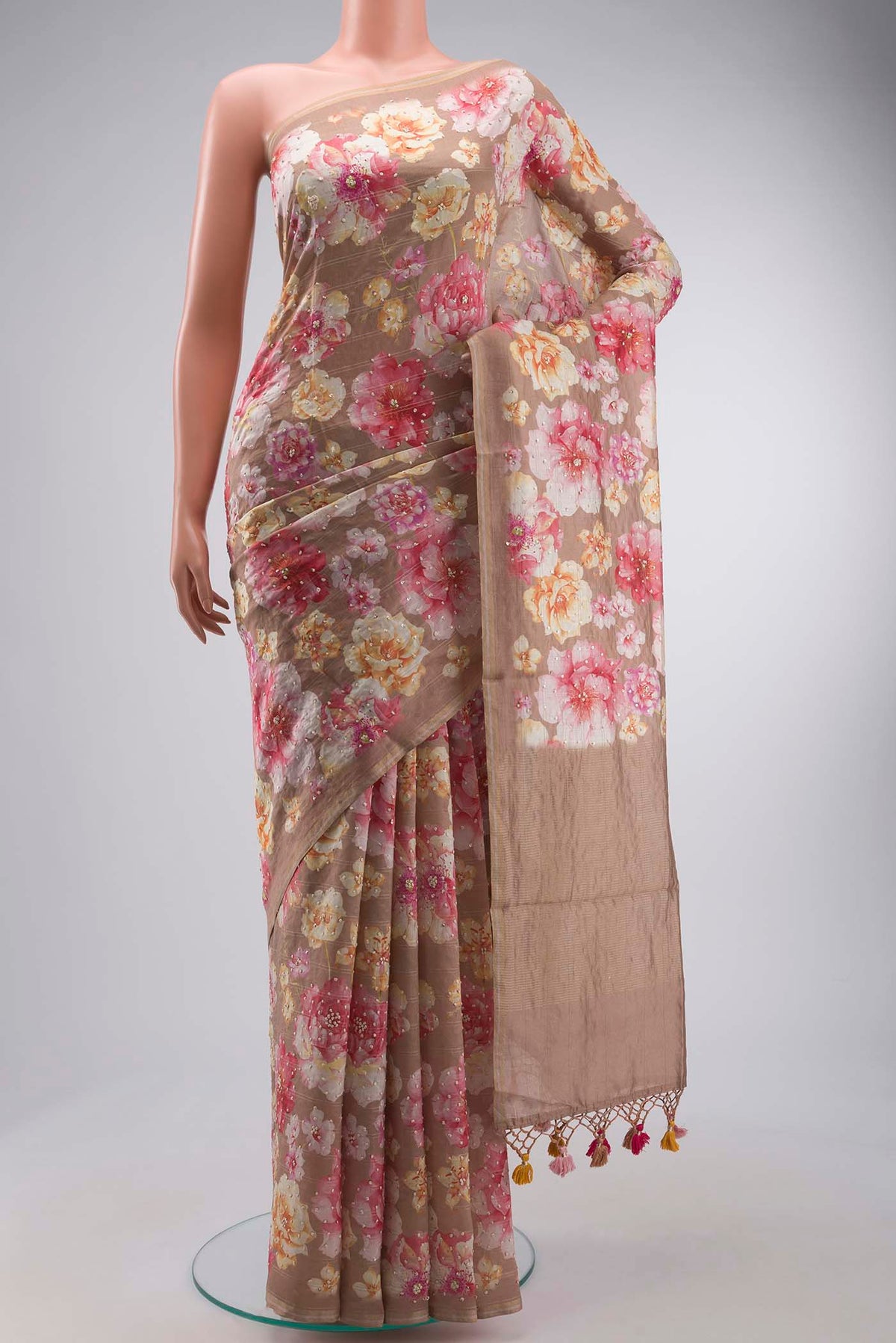 Brown Tussar Silk Saree with Printed design on the body and Zari Border displayed on a mannequin