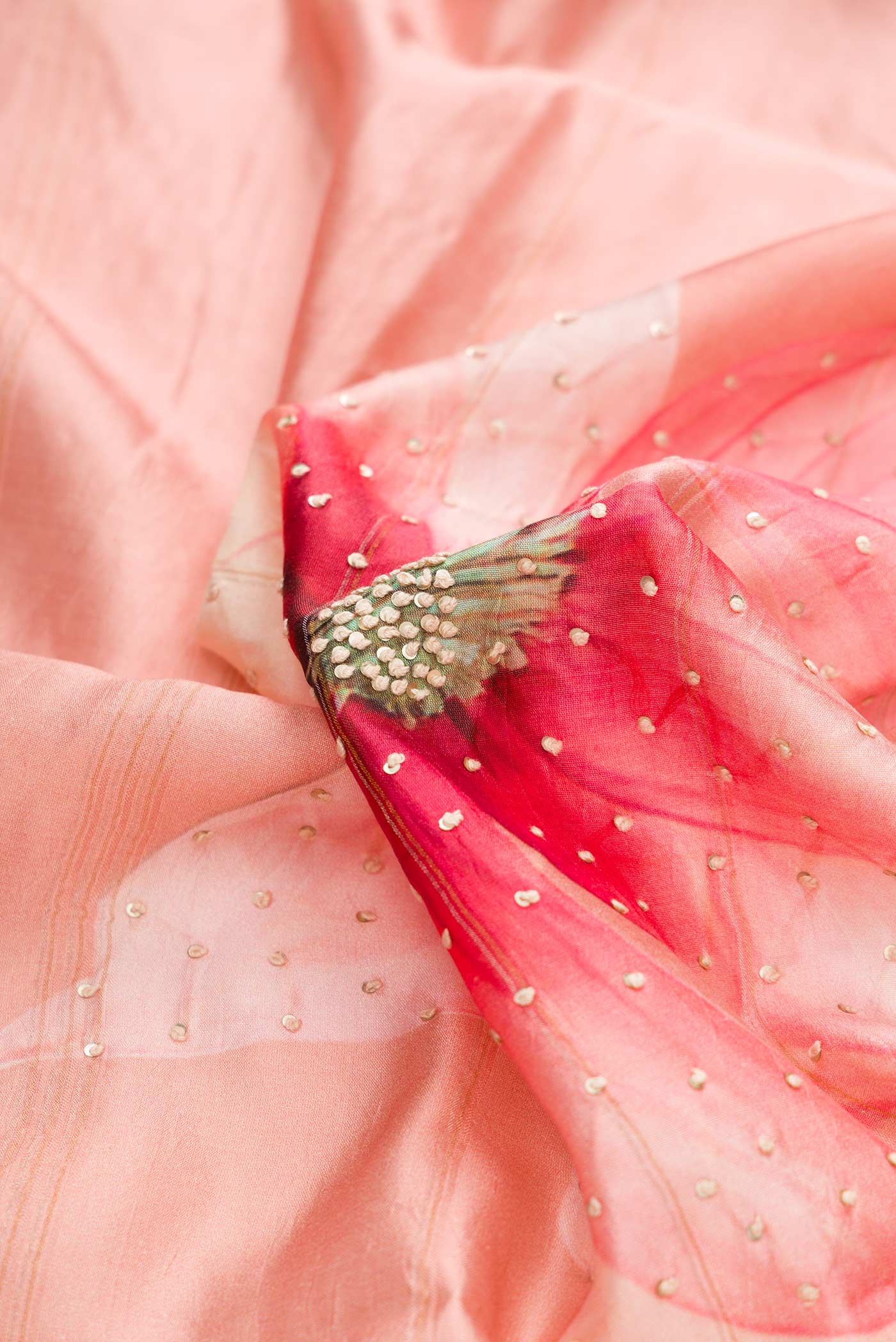 Close up of Pink Dual Tone Tussar Silk Saree with Embroidery on the body and Zari Border displaying folds