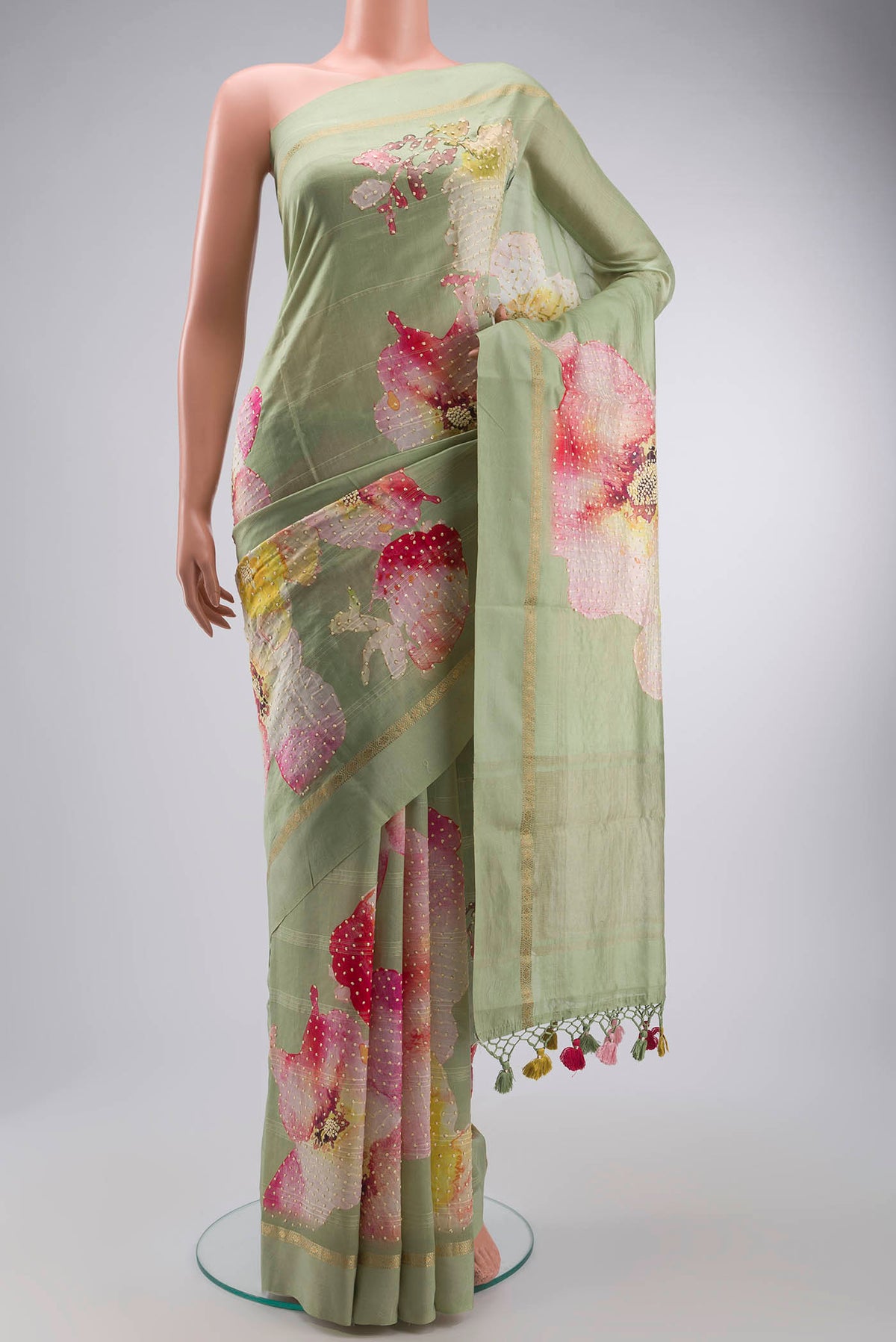 Green Tussar Silk Saree with Embroidery on the body and Zari Border displayed on a mannequin