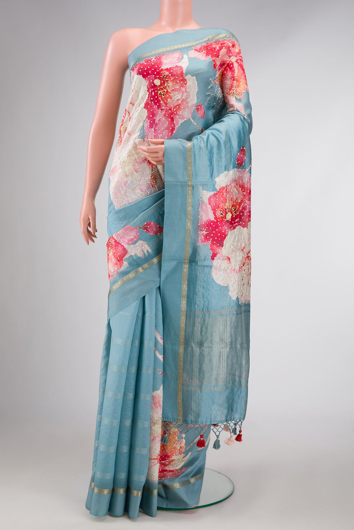 Light Blue Dual Tone Tussar Silk Saree with Embroidery on the body and Zari Border displayed on a mannequin