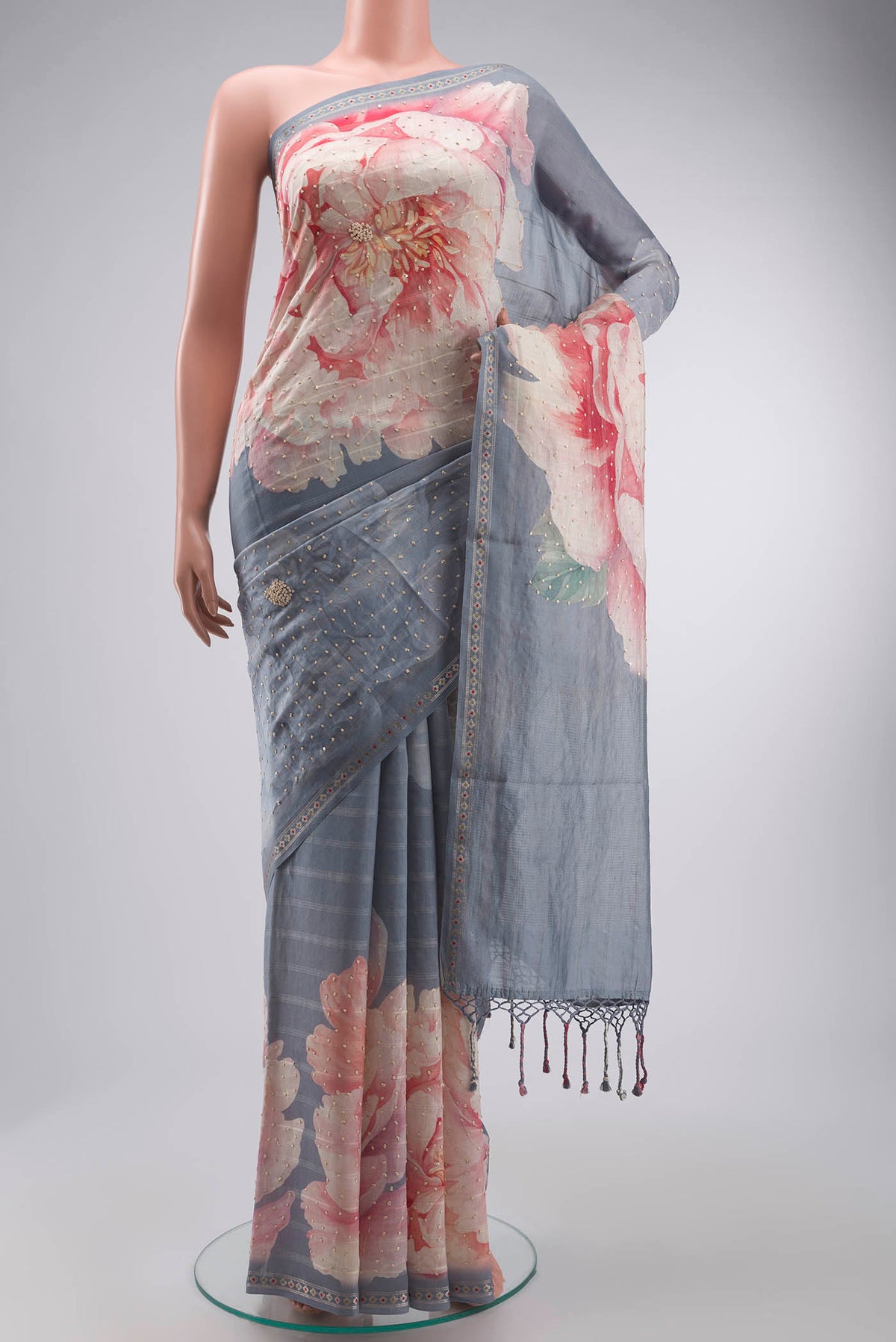 Grey Tussar Silk Saree with Embroidery on the body and Zari Border displayed on a mannequin