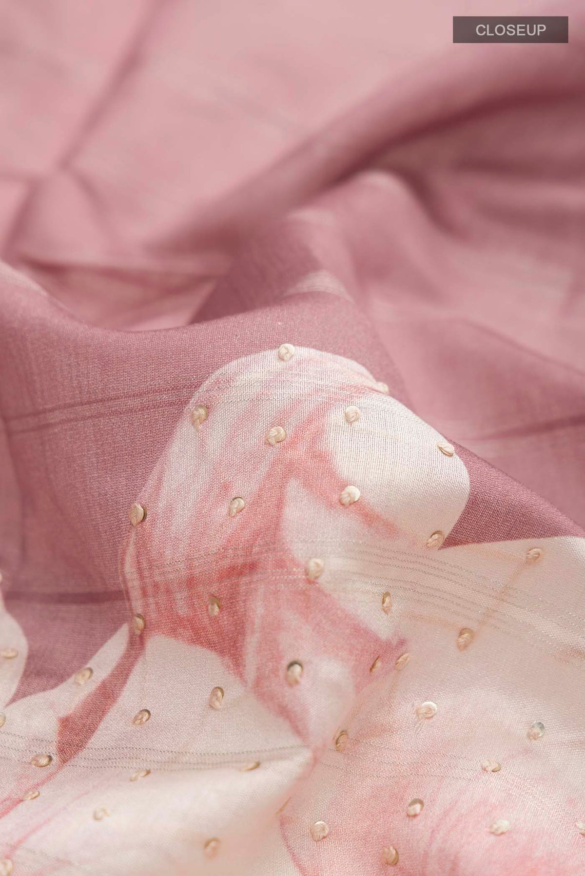 Close up of Mauve Tussar Silk Saree with Embroidery on the body and Zari Border displaying folds