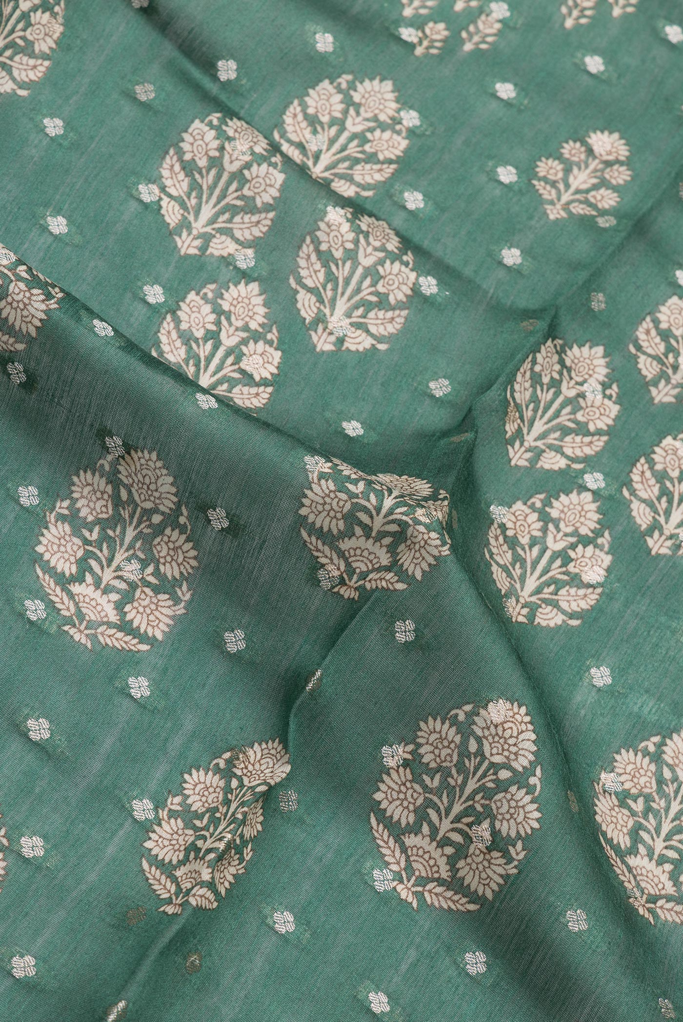 Close up of Green Dual Tone Tussar Silk Saree with Printed design on the body and Zari Border.  displaying folds