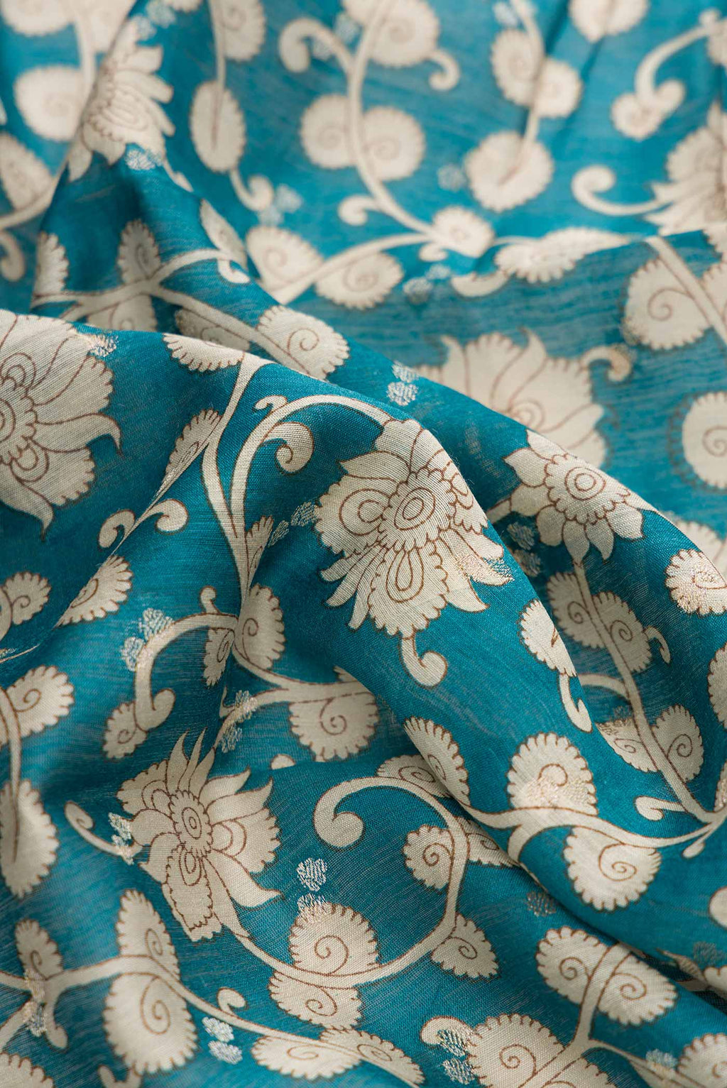 Close up of Blue Dual Tone Tussar Silk Saree with Printed design on the body and Zari Border displaying folds