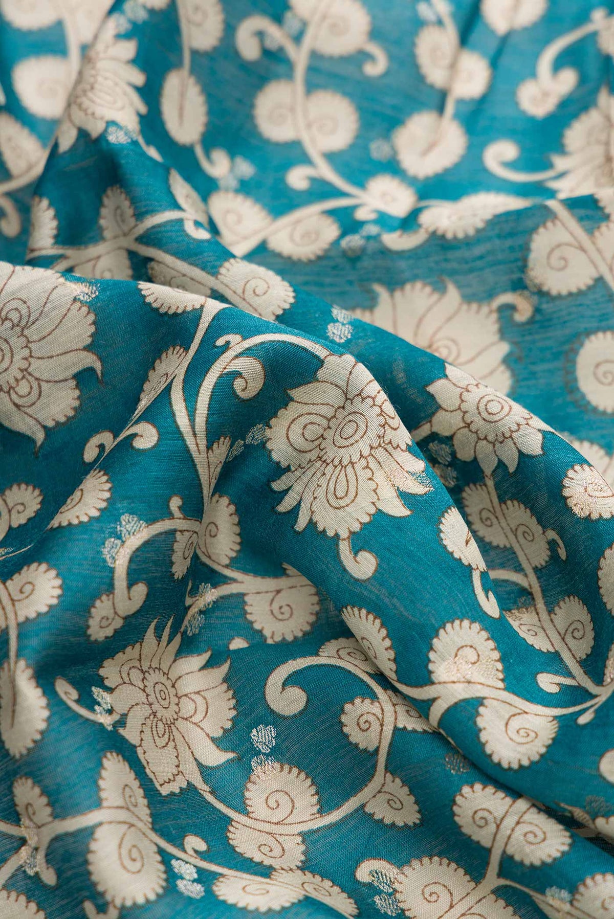 Close up of Blue Dual Tone Tussar Silk Saree with Printed design on the body and Zari Border displaying folds