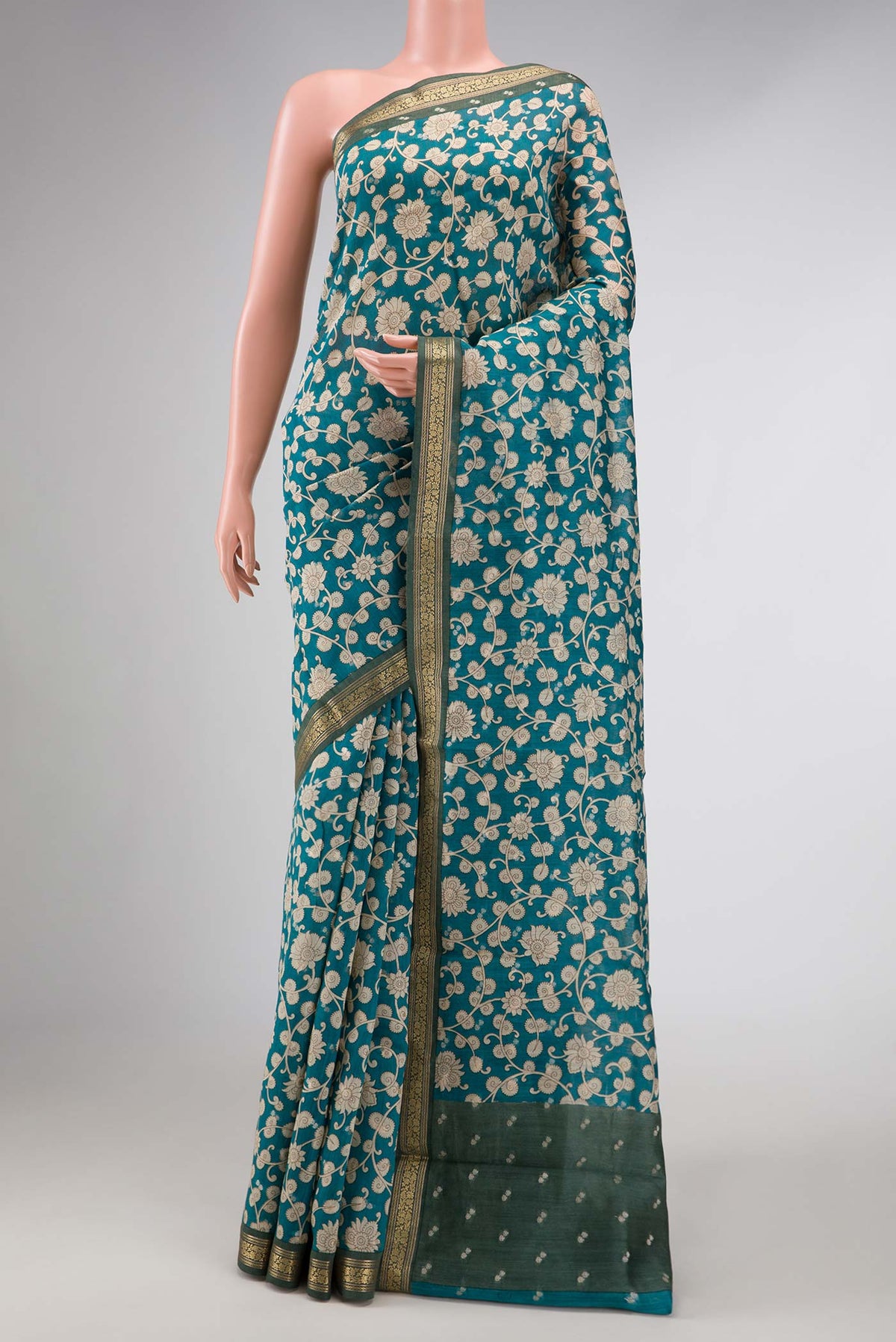 Blue Dual Tone Tussar Silk Saree with Printed design on the body and Zari Border displayed on a mannequin