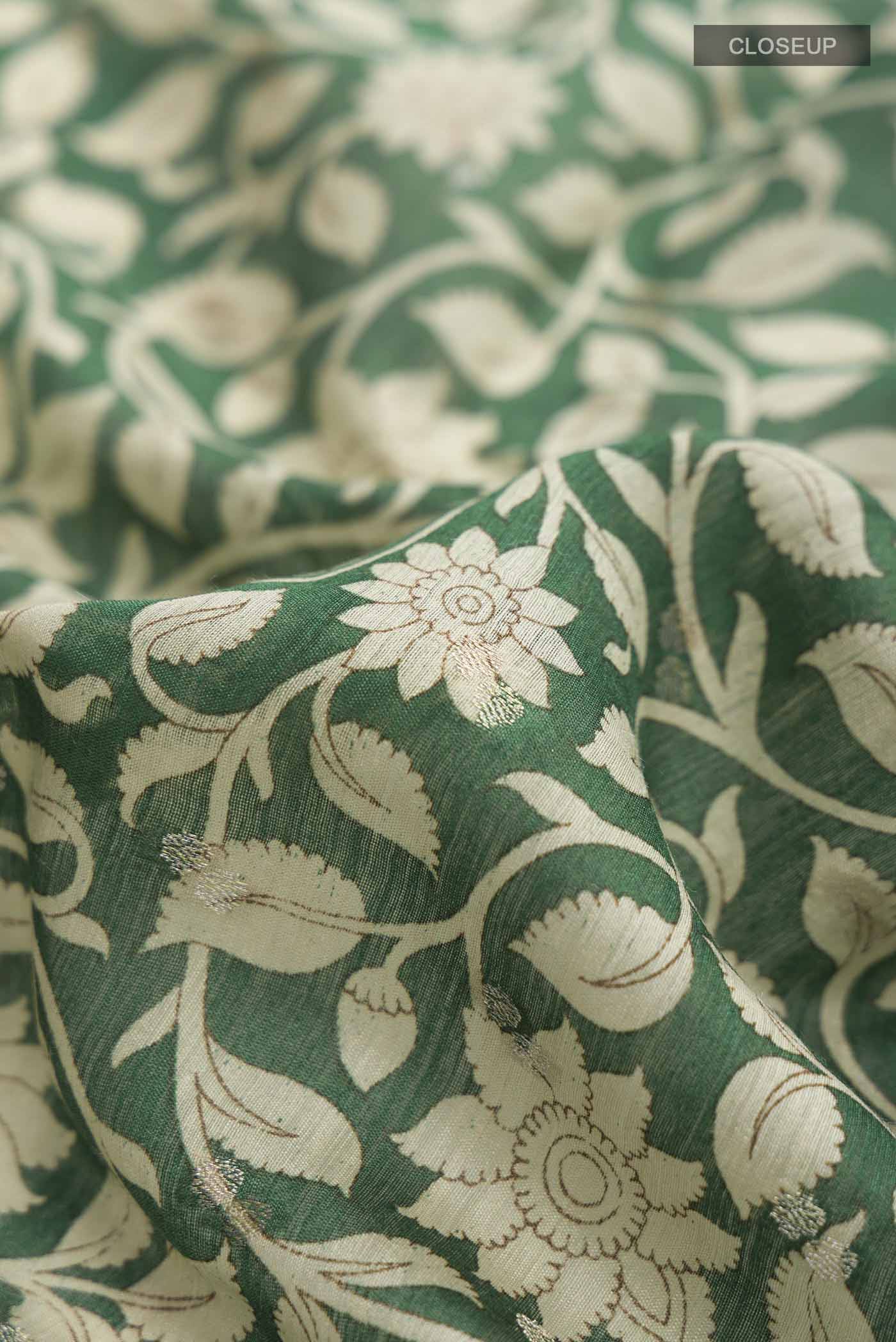 Close up of Green Bhagalpuri Tussar Silk Saree with Printed design on the body and Zari Border displaying folds