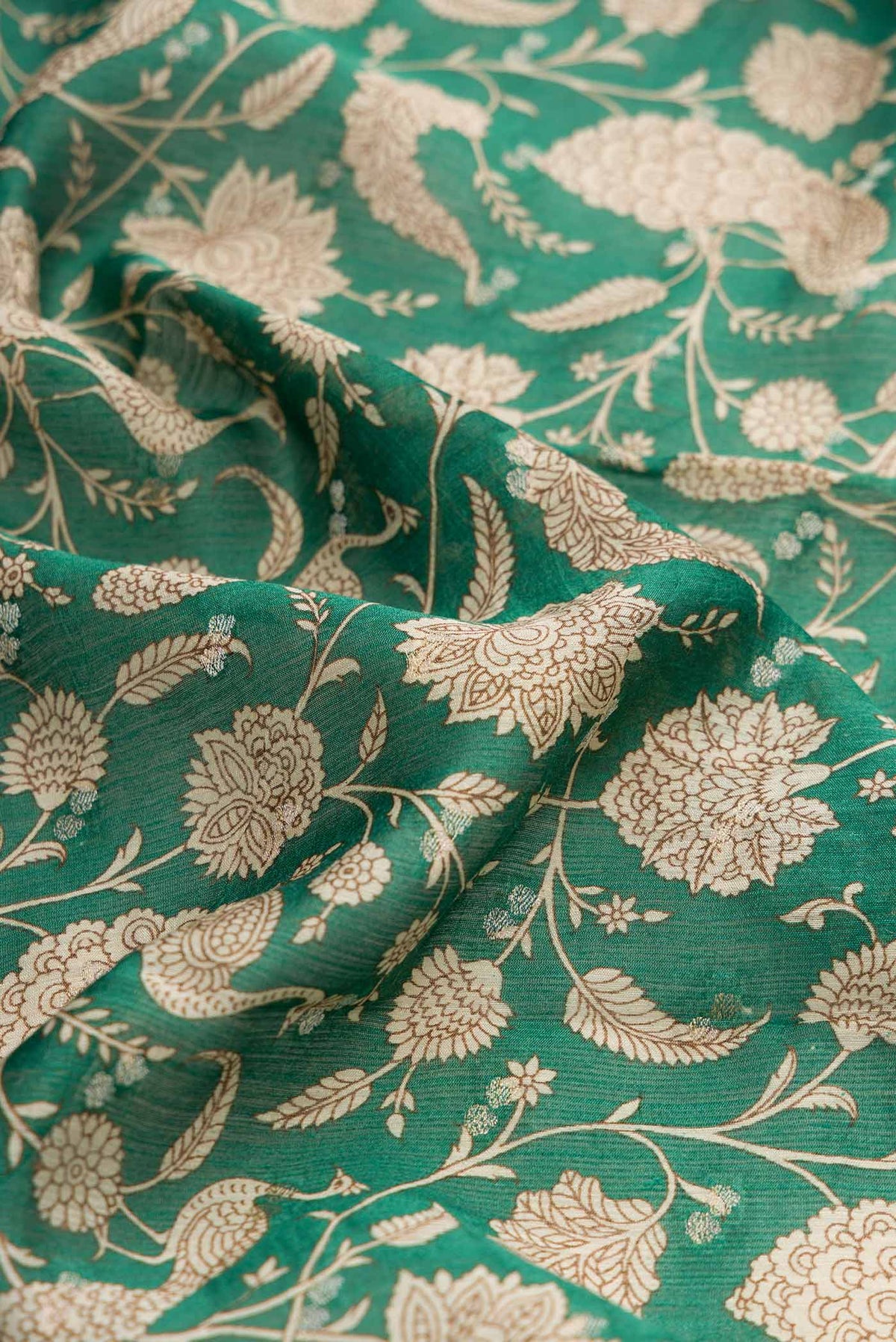 Close up of Green Dual Tone Tussar Silk Saree with Printed design on the body and Zari Border displaying folds