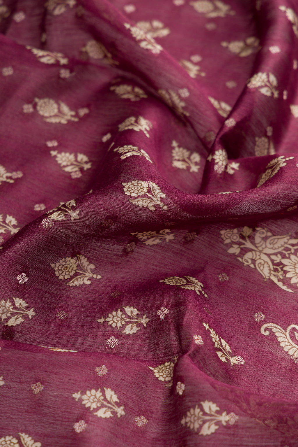 Close up of Burgundy Dual Tone Tussar Silk Saree with Printed design on the body and Zari Border.  displaying folds