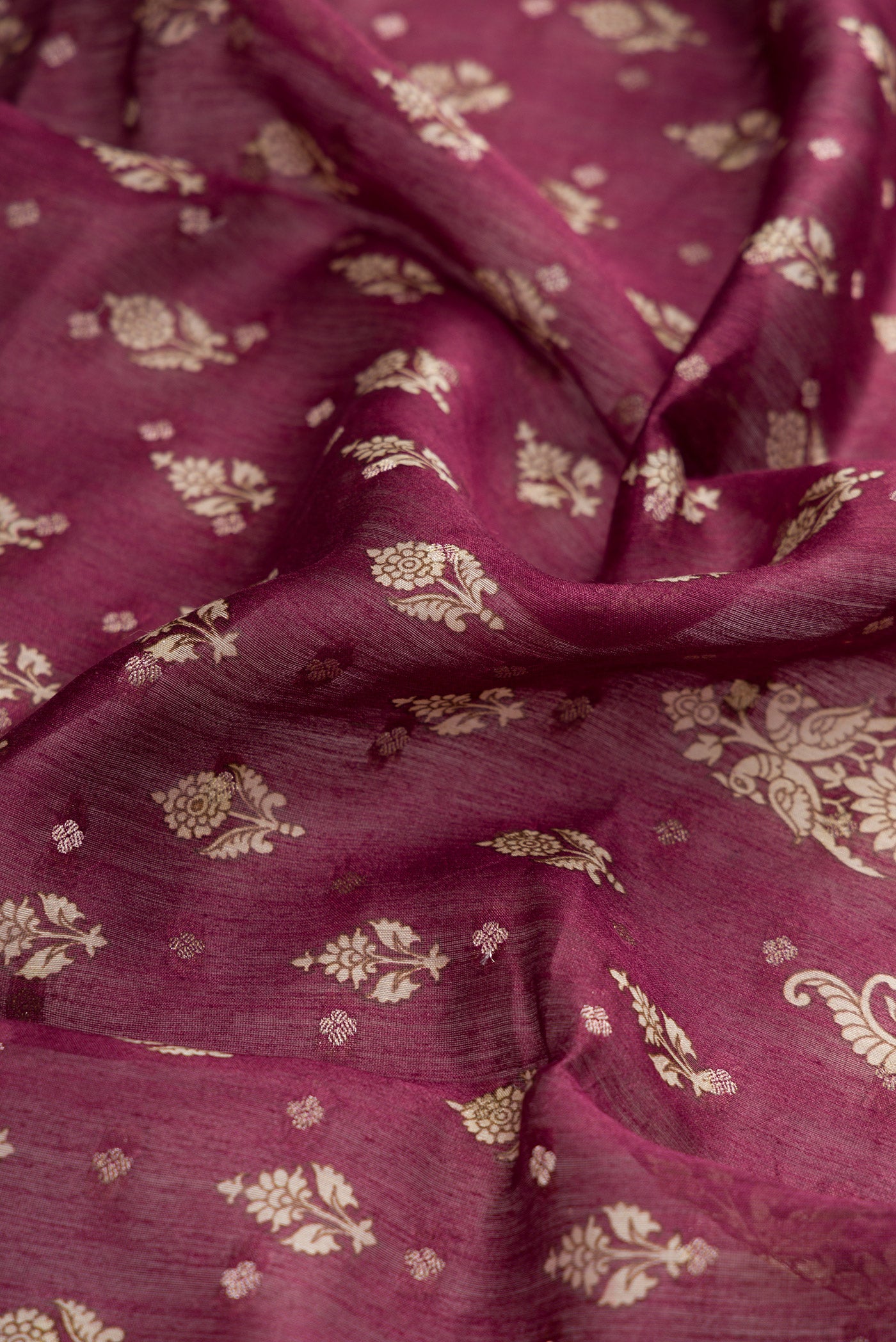 Close up of Burgundy Dual Tone Tussar Silk Saree with Printed design on the body and Zari Border.  displaying folds