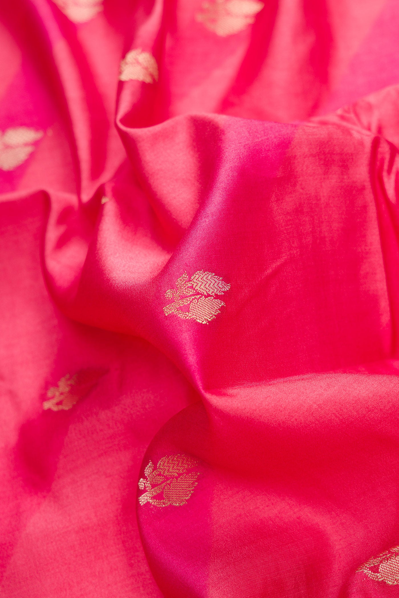 Close up of Pink Dual Tone Tussar Silk Saree with Zari Butta on the body and Zari Border.  displaying folds