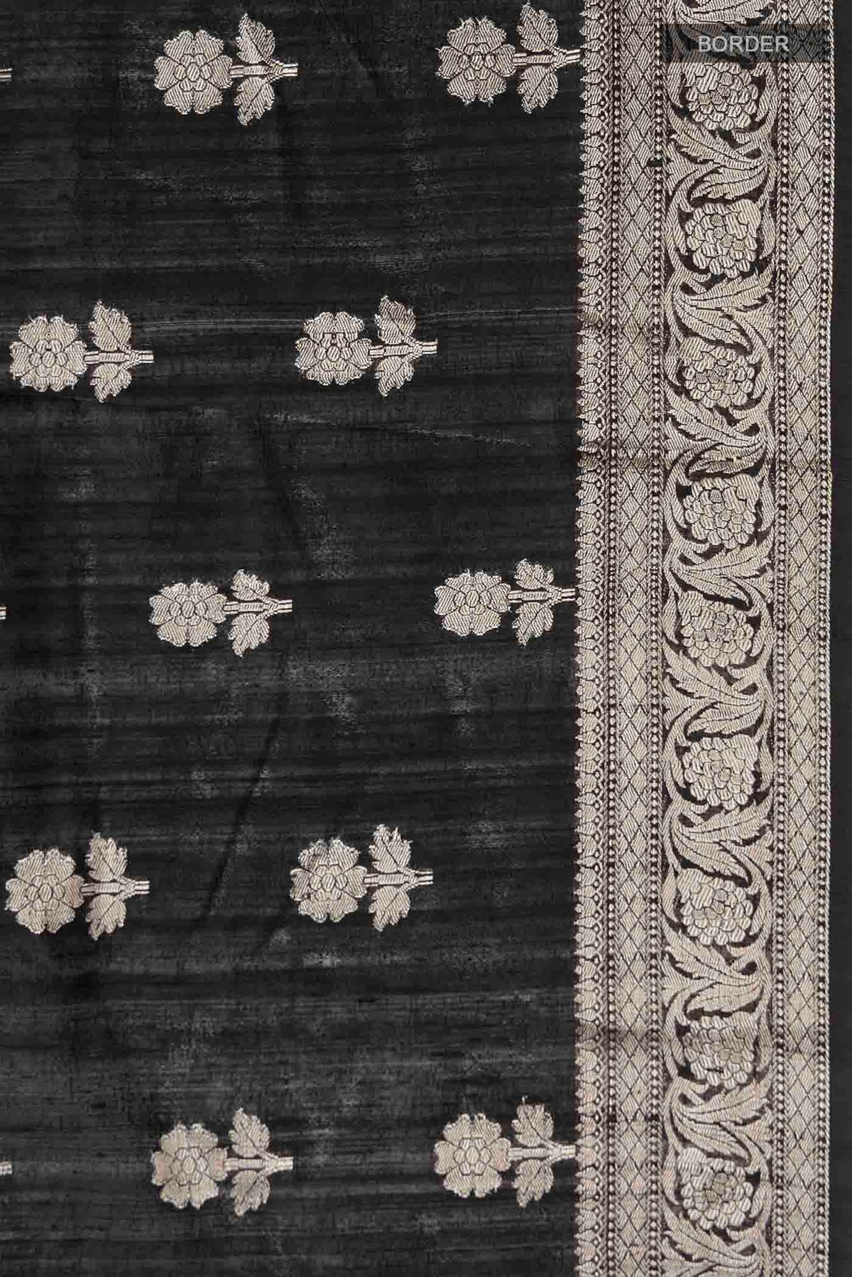 Border image of Black Tussar Silk Saree with Zari Butta on the body and Zari Border