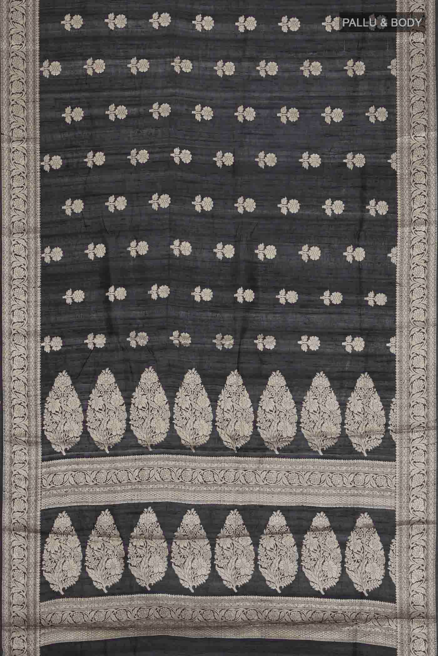 Flat view of Black Tussar Silk Saree with Zari Butta on the body and Zari Border