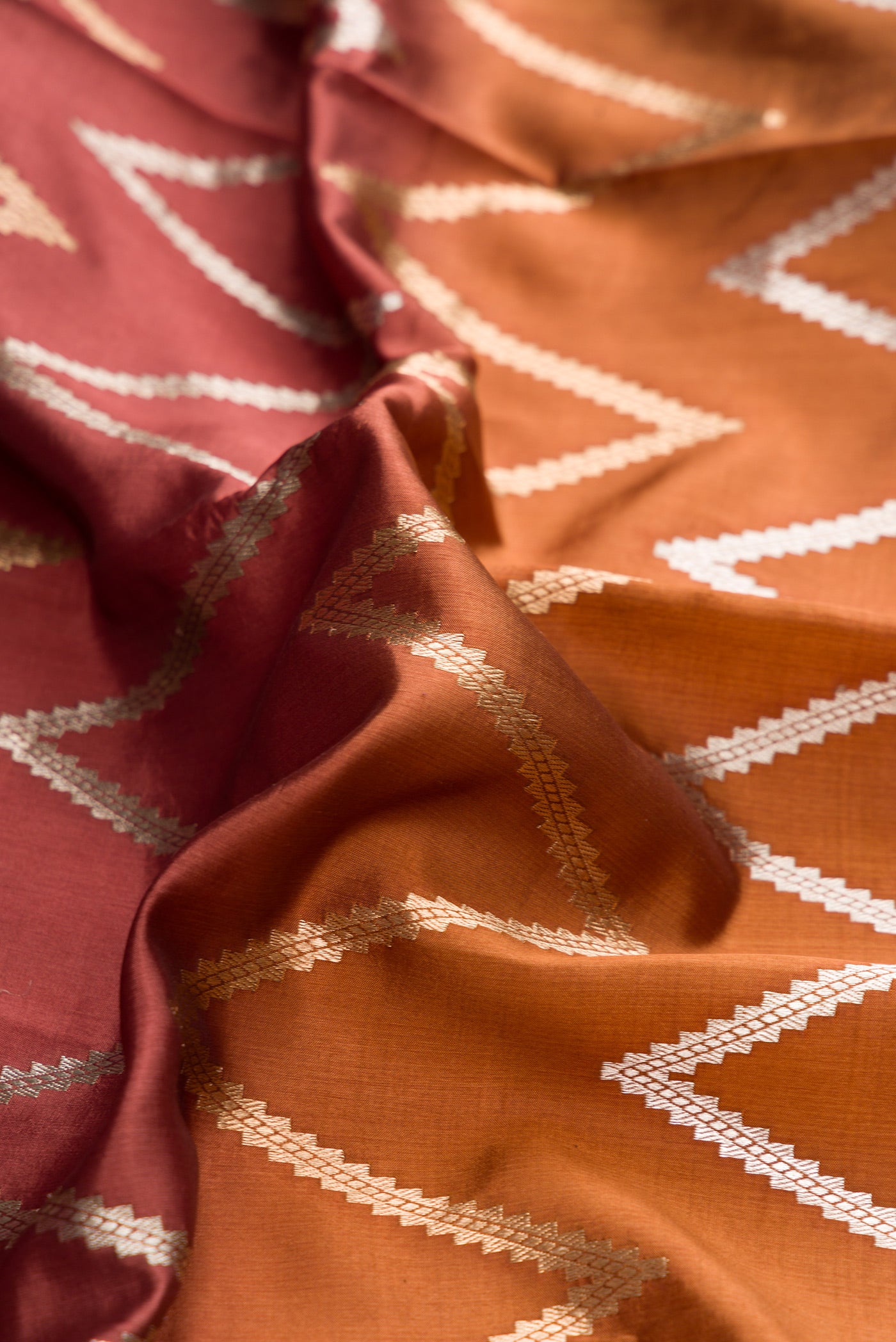 Close up of Brown and Beige Color Tussar Silk Saree with Stripes on the body and Plain Border.  displaying folds