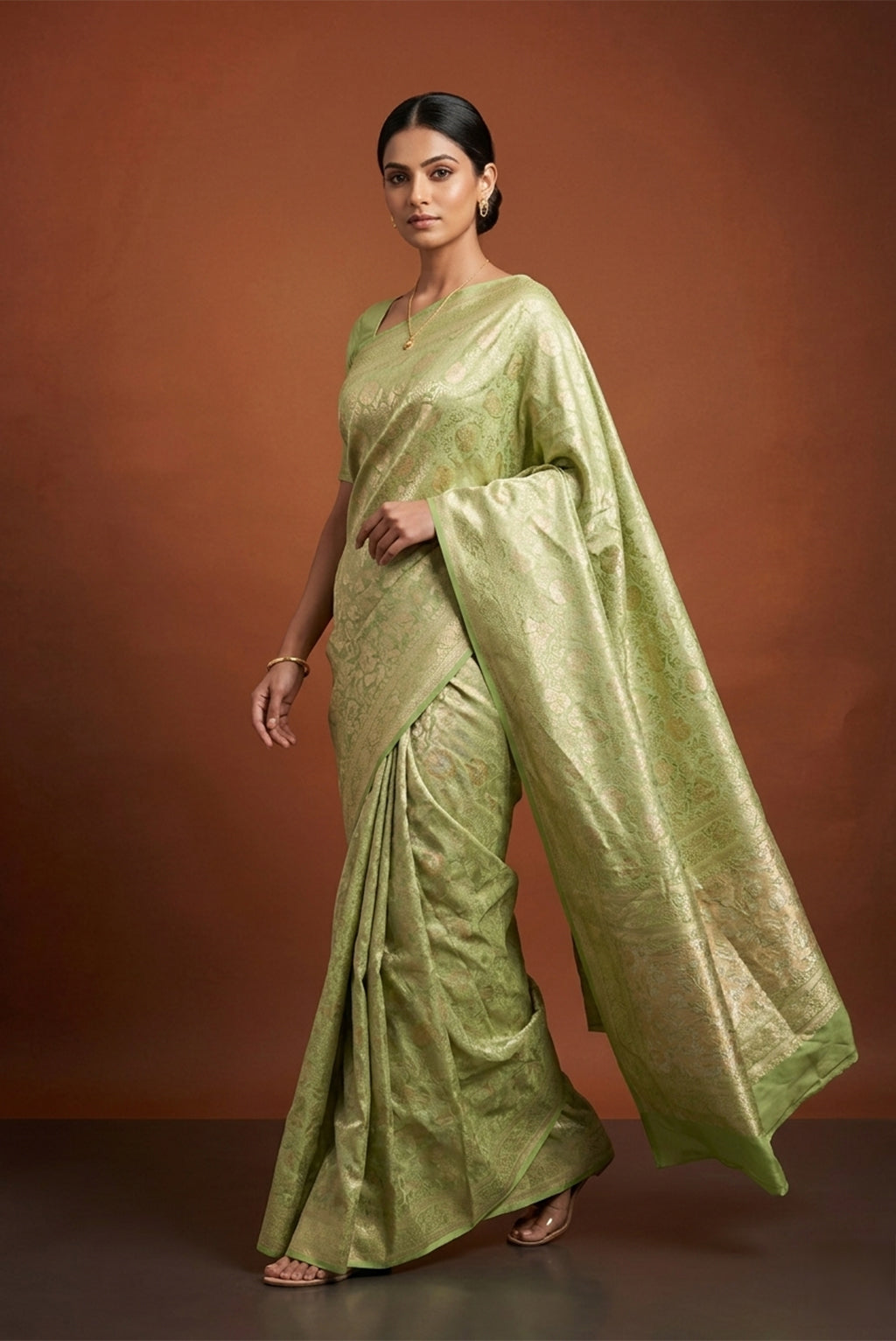 Model wearing a Pista Green Banarasi Silk Saree with Zari Brocade on the body and Zari Border.