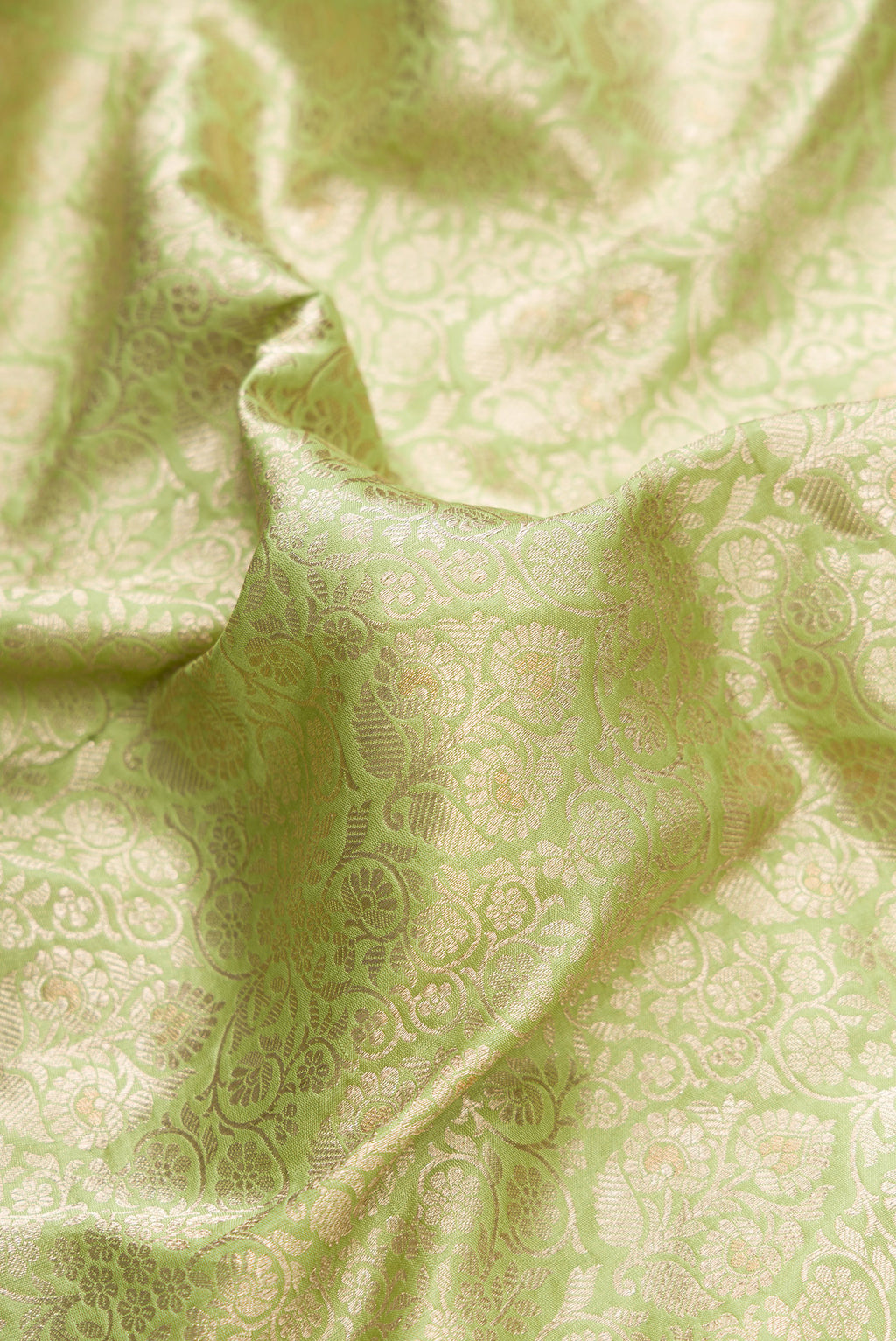 Close up of Pista Green Dual Tone Banarasi Silk Saree with Zari Brocade on the body and Zari Border.  displaying folds