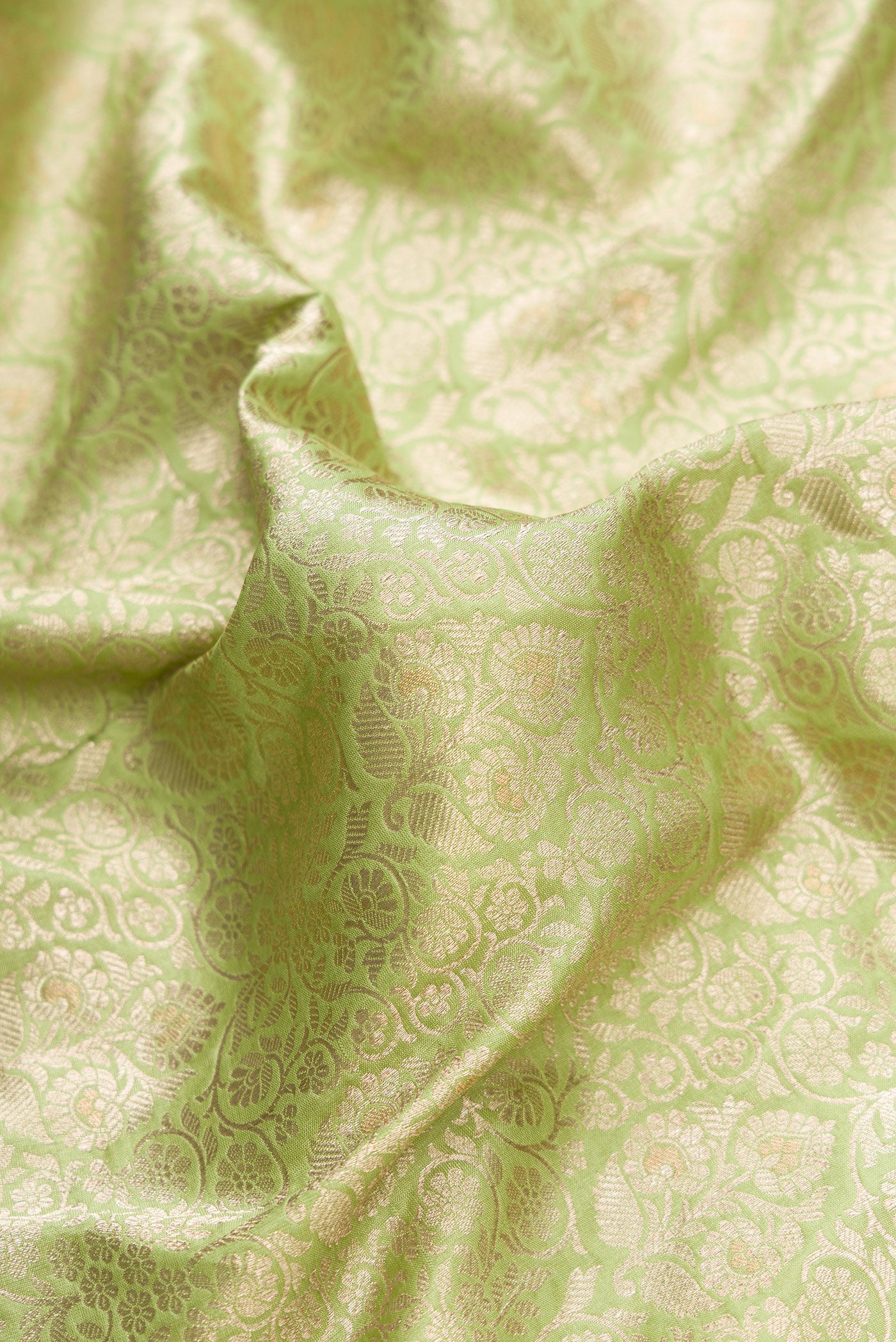 Close up of Pista Green Dual Tone Banarasi Silk Saree with Zari Brocade on the body and Zari Border.  displaying folds