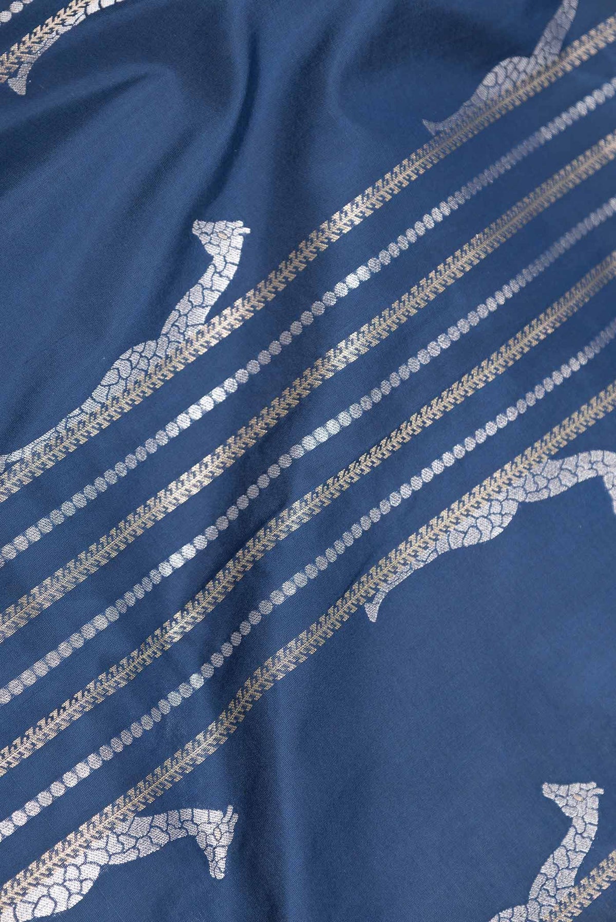 Close up of Navy Blue Dual Tone Banarasi Saree with Stripes on the body and Zari Border displaying folds
