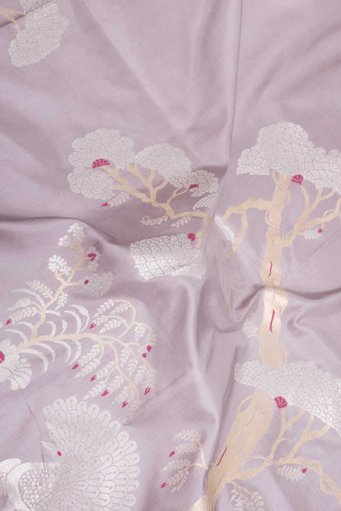 Close up of Lavender Dual Tone Banarasi Saree with Zari Butta on the body and Fancy Border displaying folds