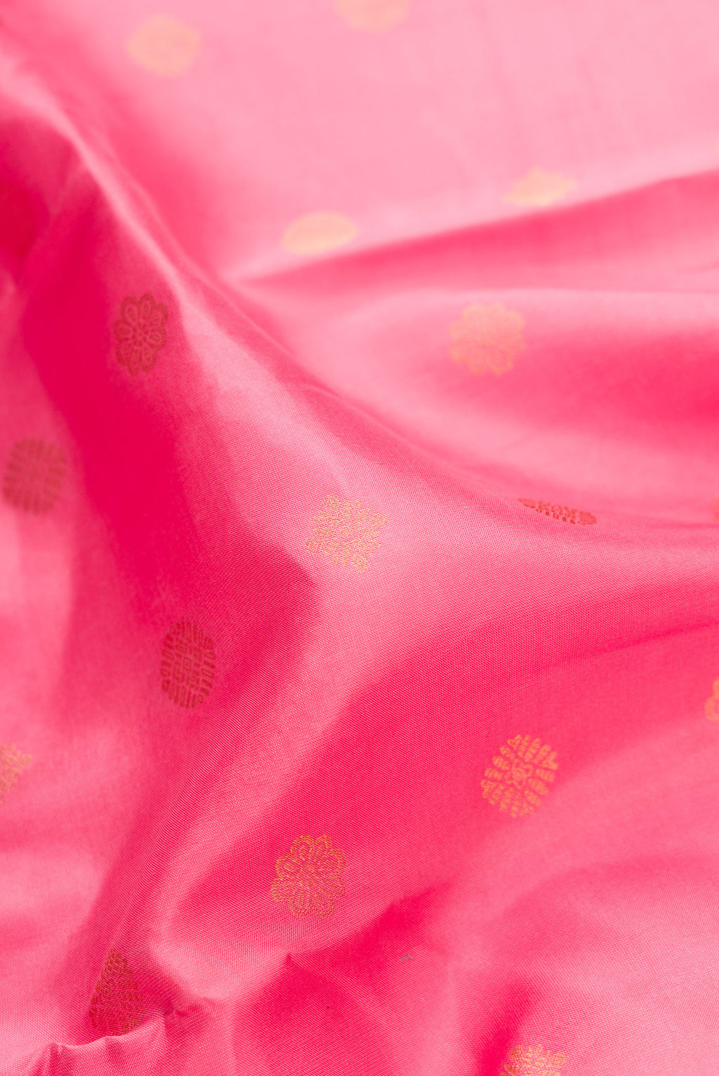 Close up of Pink Dual Tone Kanchipuram Silk Saree with Zari Butta on the body and Zari Border.  displaying folds