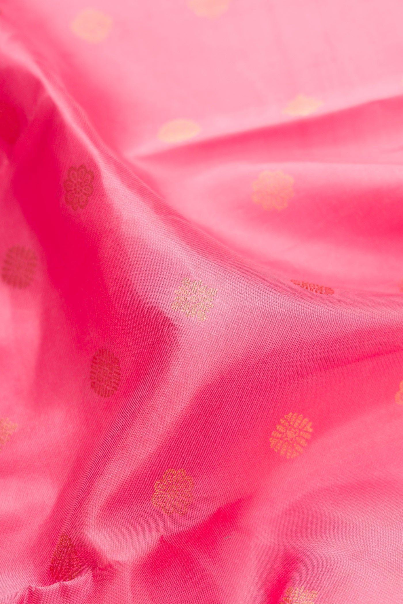 Close up of Pink Dual Tone Kanchipuram Silk Saree with Zari Butta on the body and Zari Border.  displaying folds