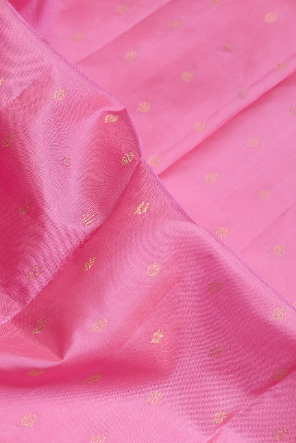 Close up of Pink Dual Tone Kanchipuram Silk Saree with Zari Butta on the body and Fancy Border.  displaying folds