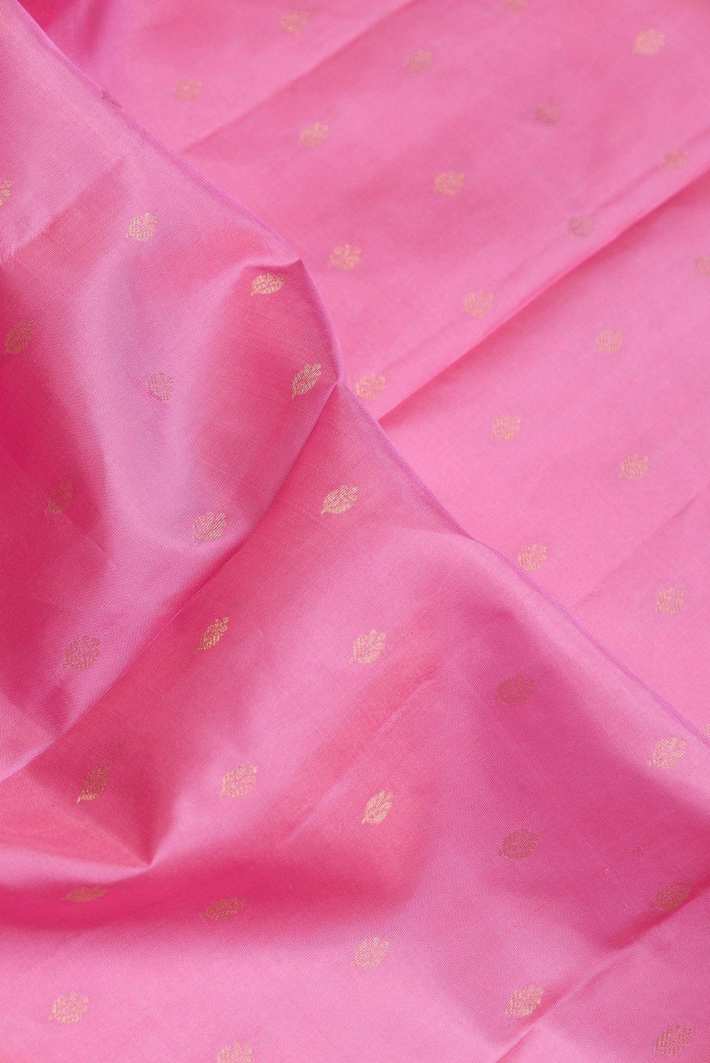 Close up of Pink Dual Tone Kanchipuram Silk Saree with Zari Butta on the body and Fancy Border.  displaying folds