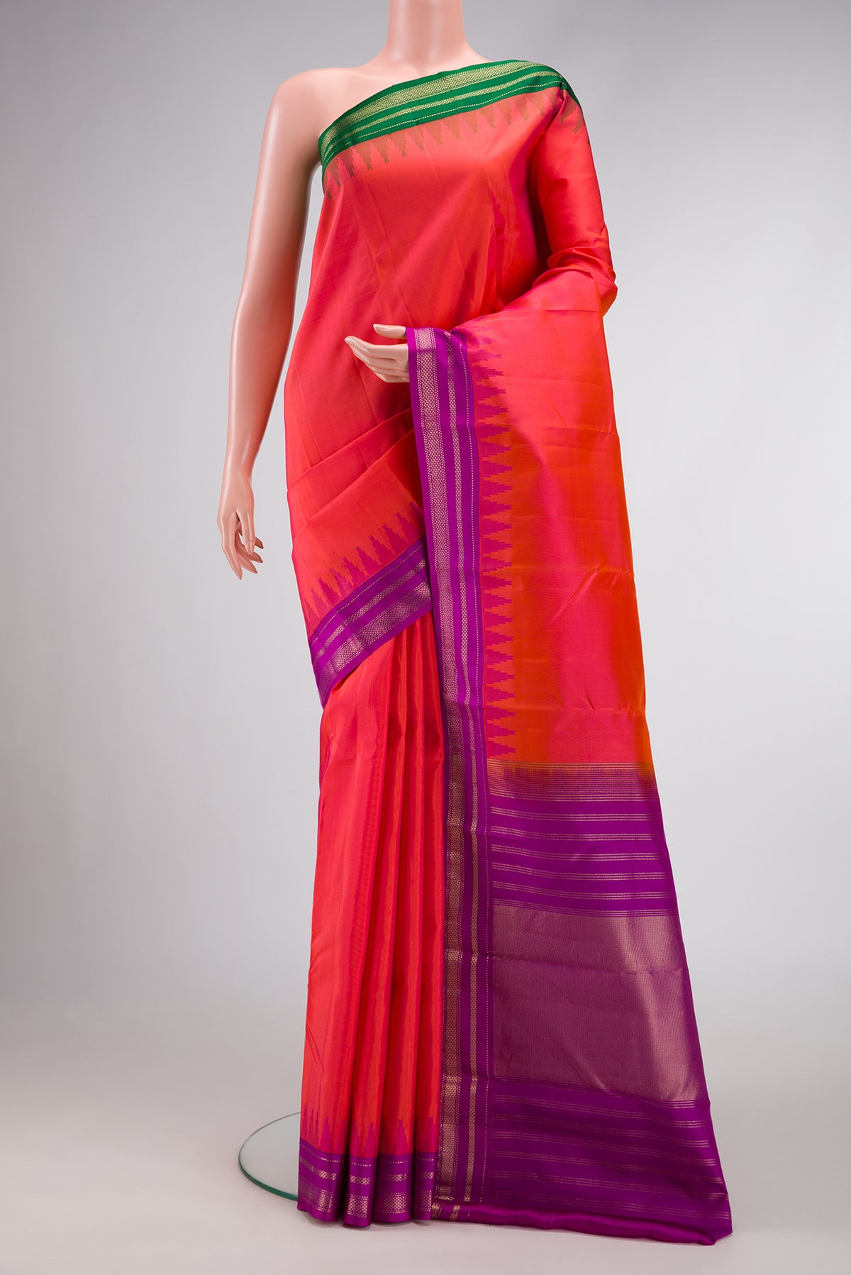 Coral Dual Tone Kanchipuram Silk Saree with Plain Body and Ganga Jamuna Border.  displayed on a mannequin