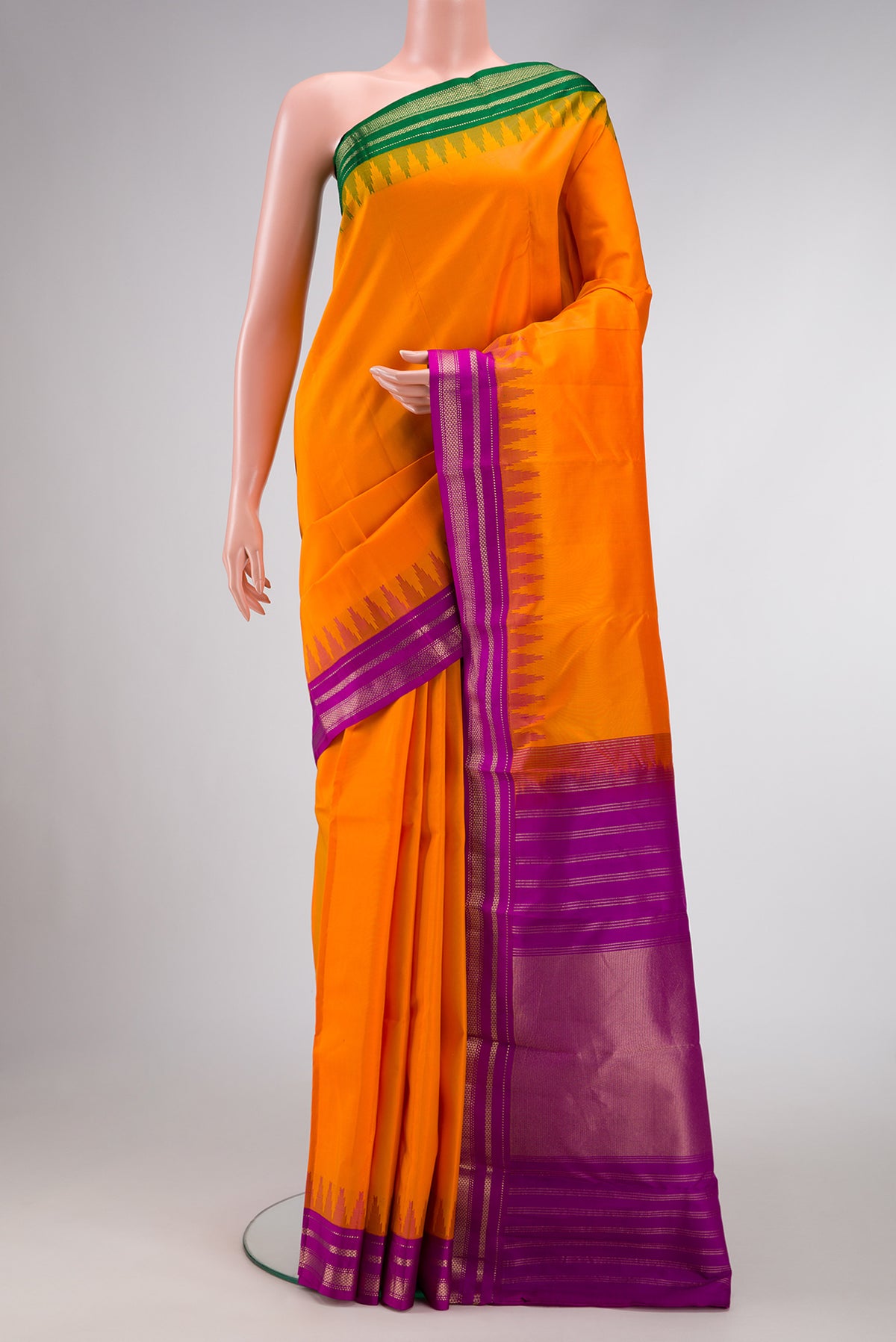 Orange Dual Tone Kanchipuram Silk Saree with Plain Body and Ganga Jamuna Border.  displayed on a mannequin