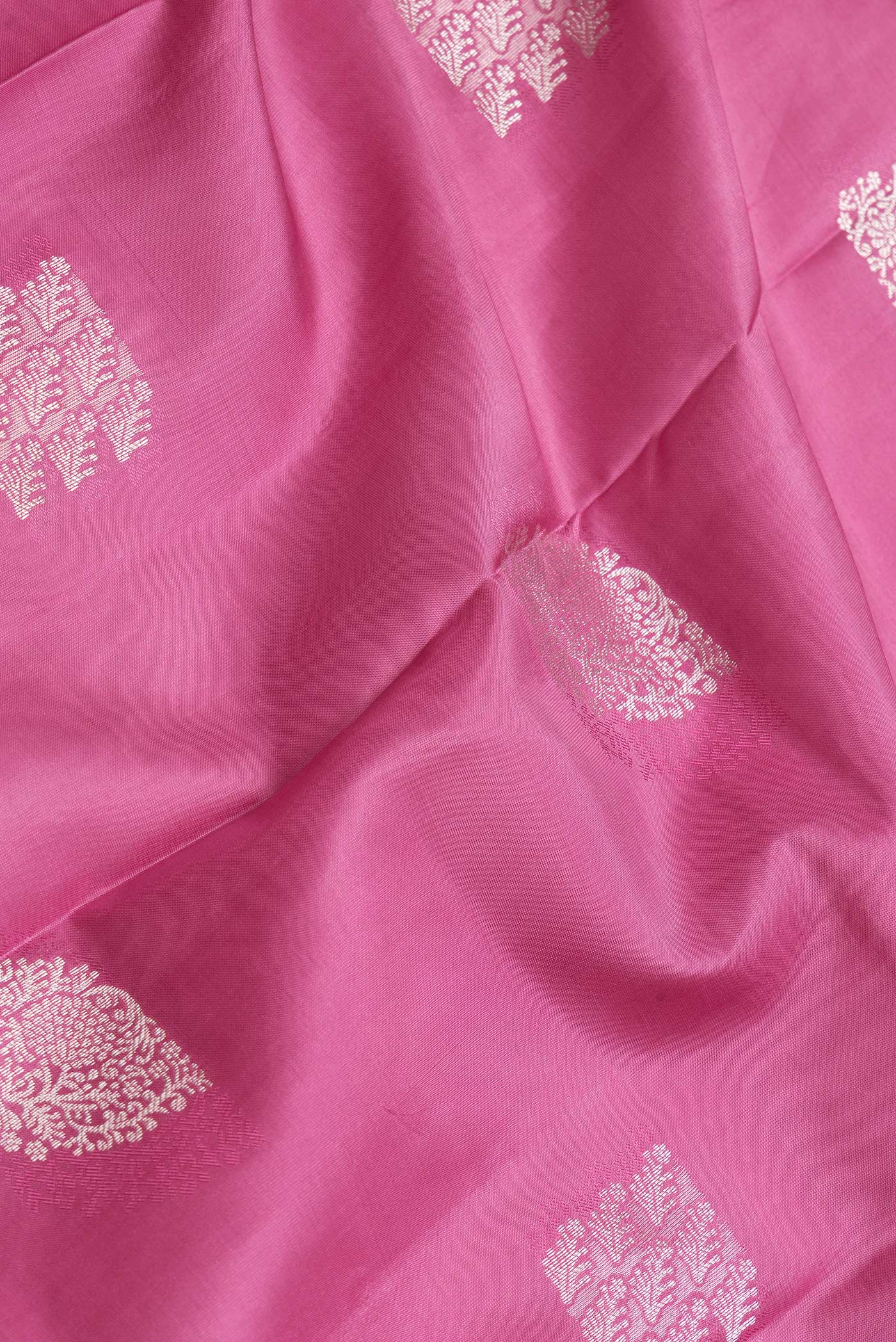Close up of Pink Dual Tone Kanchipuram Silk Saree with Zari Butta on the body and Zari Border.  displaying folds