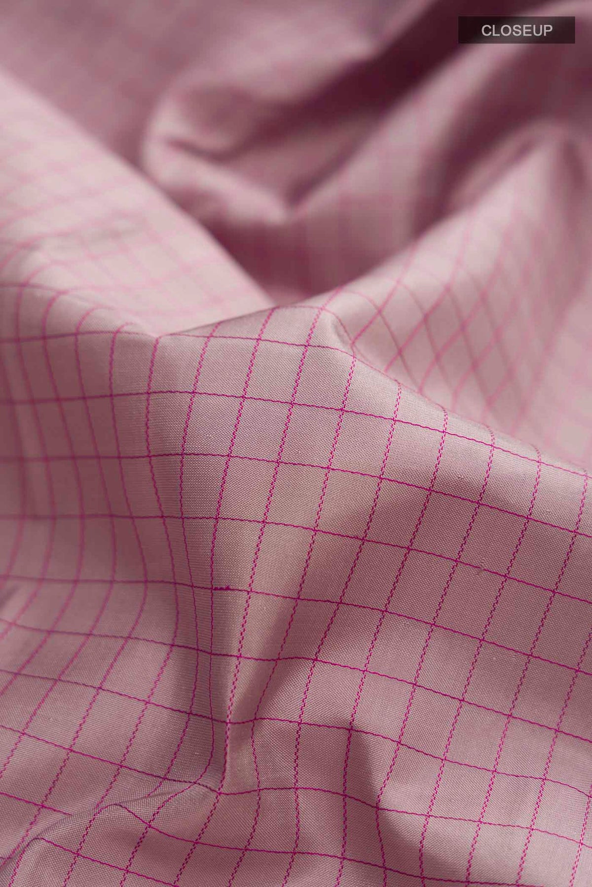 Close up of Mauve Kanchipuram Silk Saree with Checked design on the body and Zari Border displaying folds