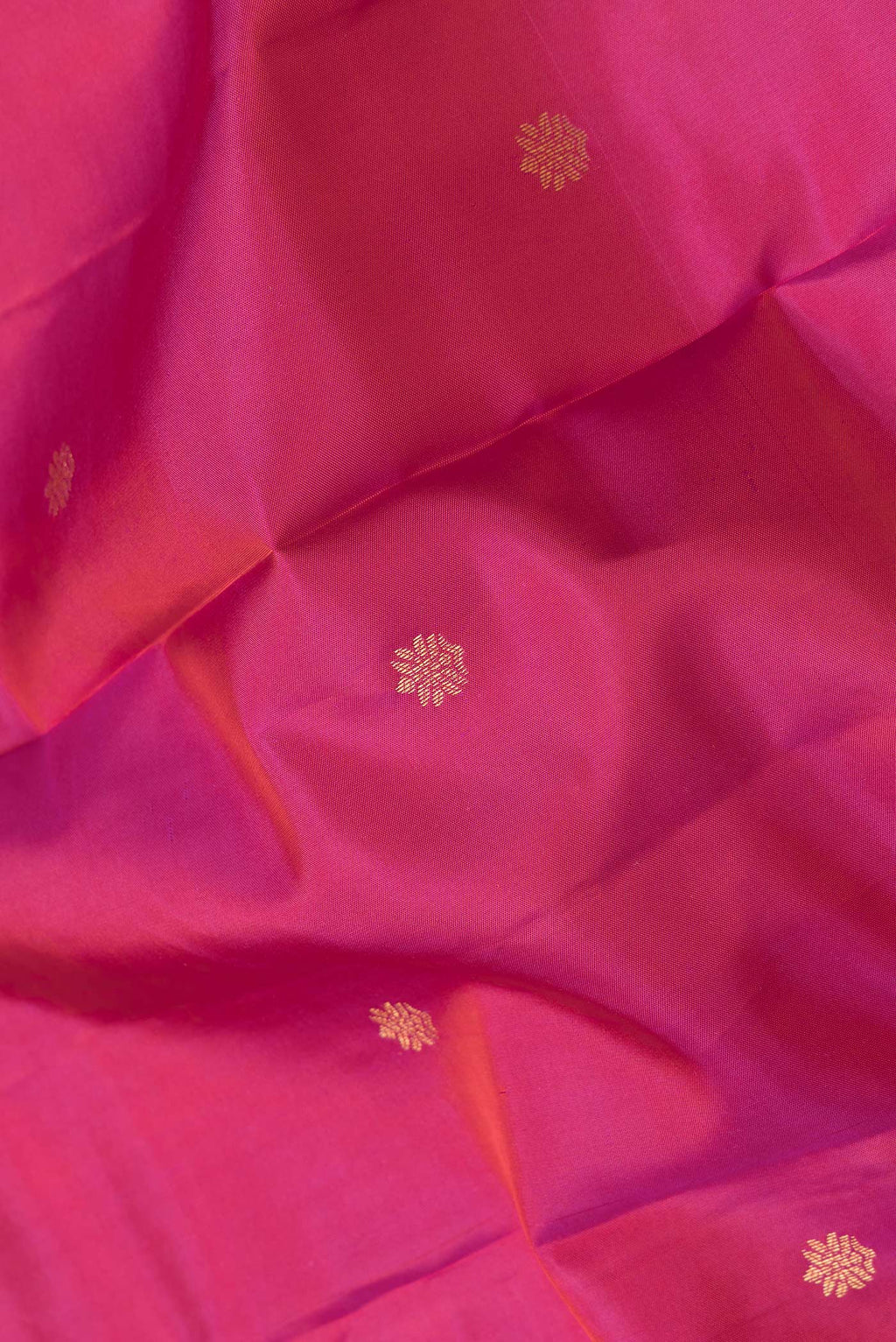 Close up of Pink Dual Tone Kanchipuram Silk Saree with Zari Butta on the body and Zari Border.  displaying folds