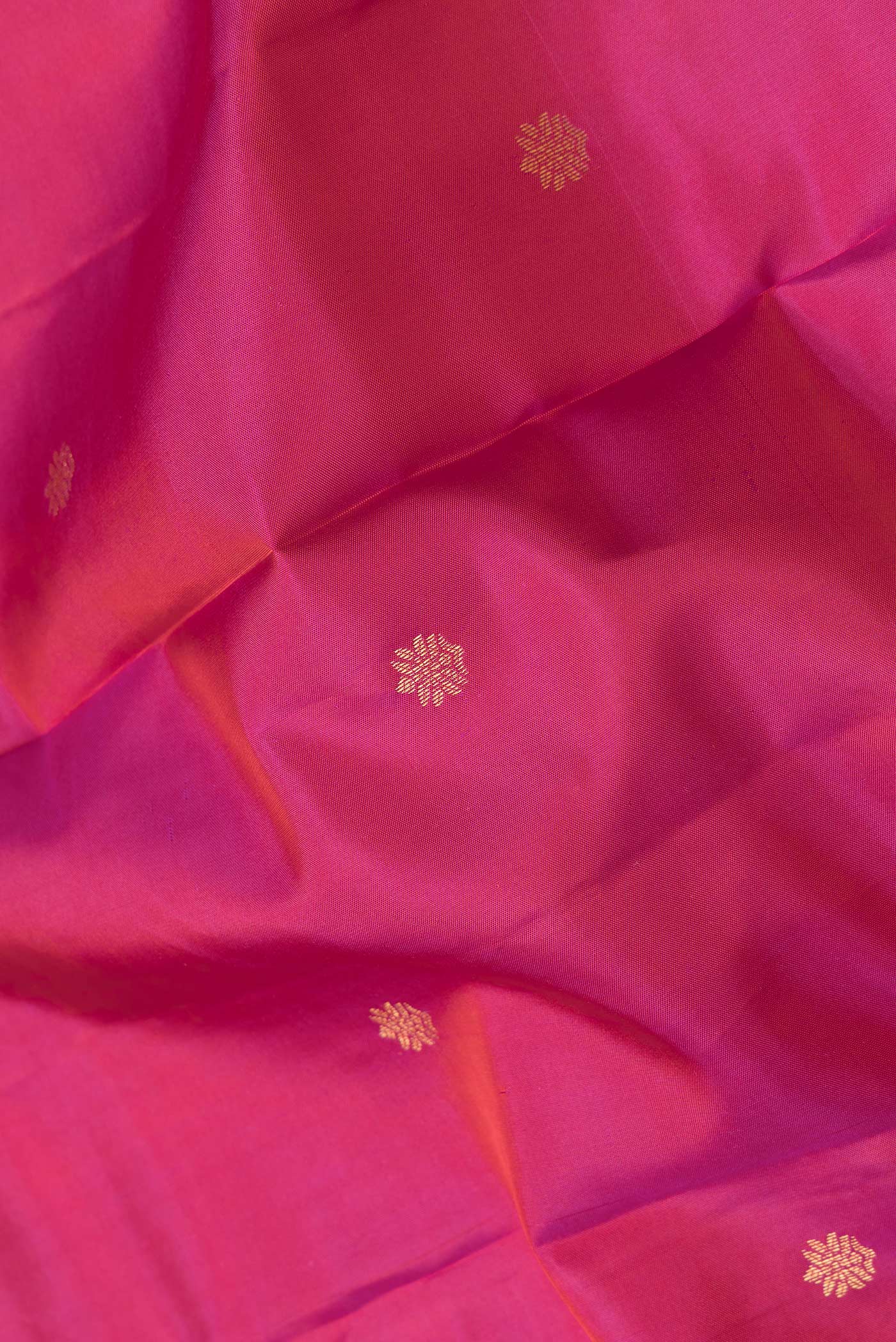 Close up of Pink Dual Tone Kanchipuram Silk Saree with Zari Butta on the body and Zari Border.  displaying folds