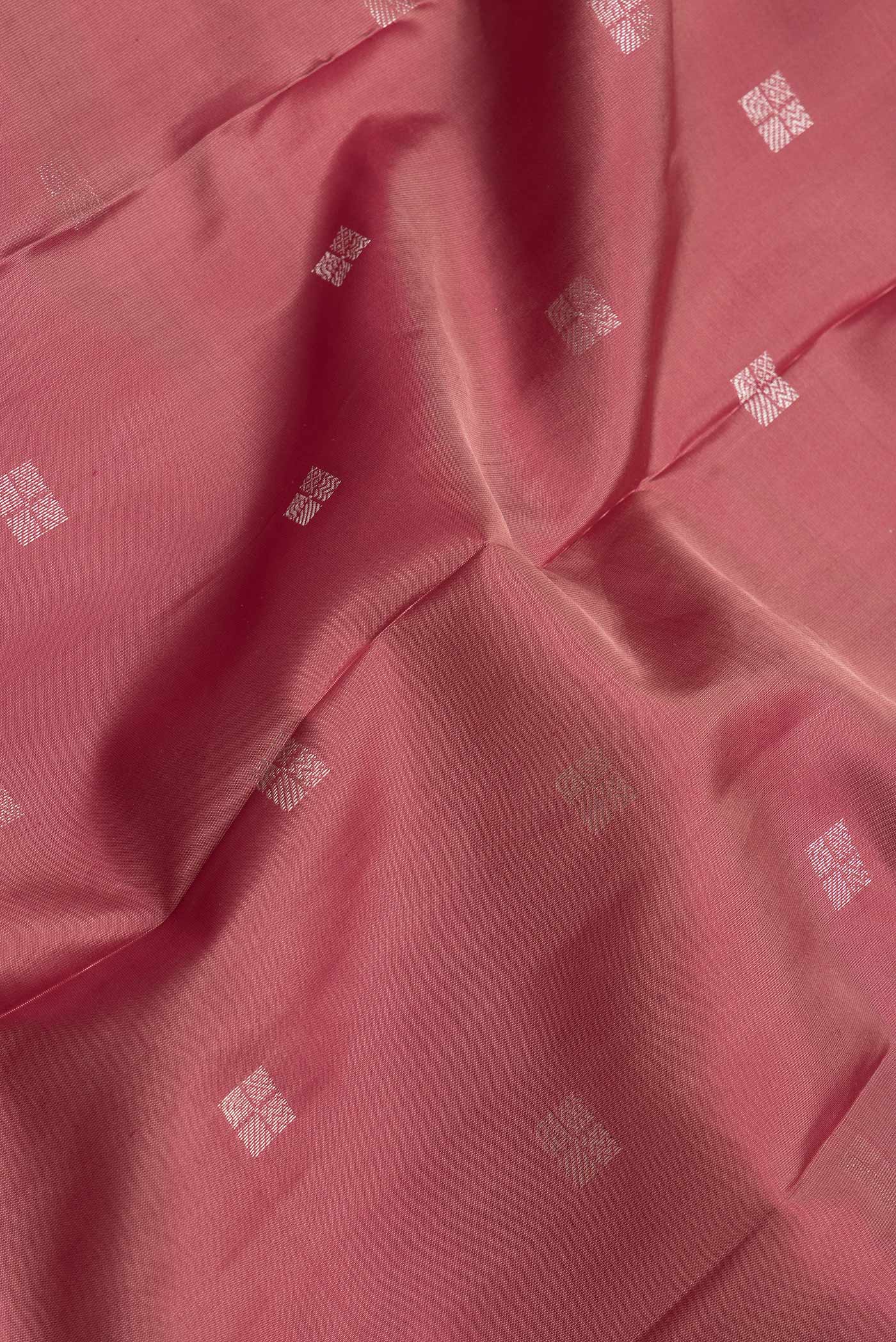 Close up of Brown Dual Tone Kanchipuram Silk Saree with Zari Butta on the body and Zari Border.  displaying folds