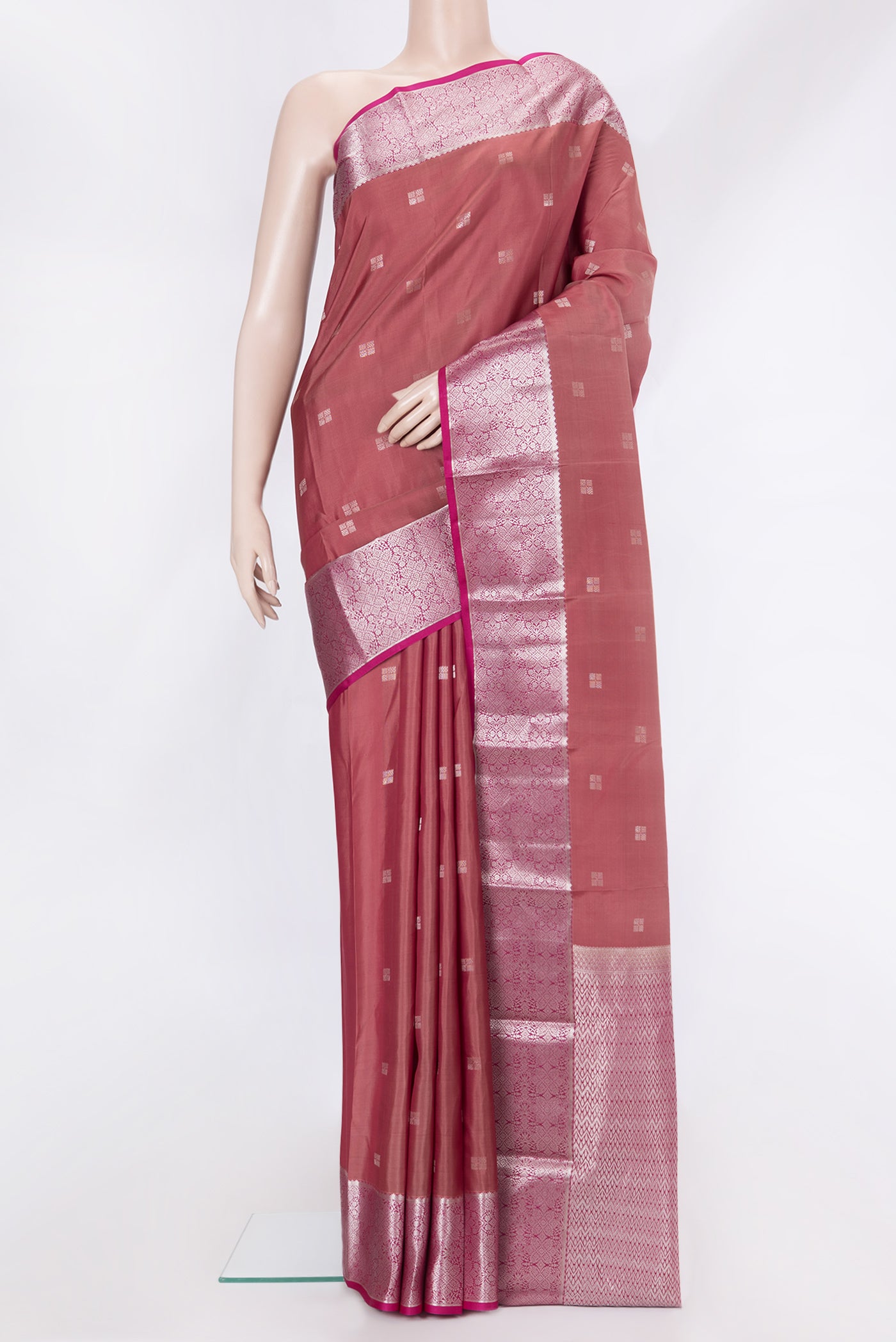 Brown Dual Tone Kanchipuram Silk Saree with Zari Butta on the body and Zari Border.  displayed on a mannequin