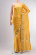 Yellow Soft Silk Saree with Zari Butta on the body and Zari Border displayed on a mannequin