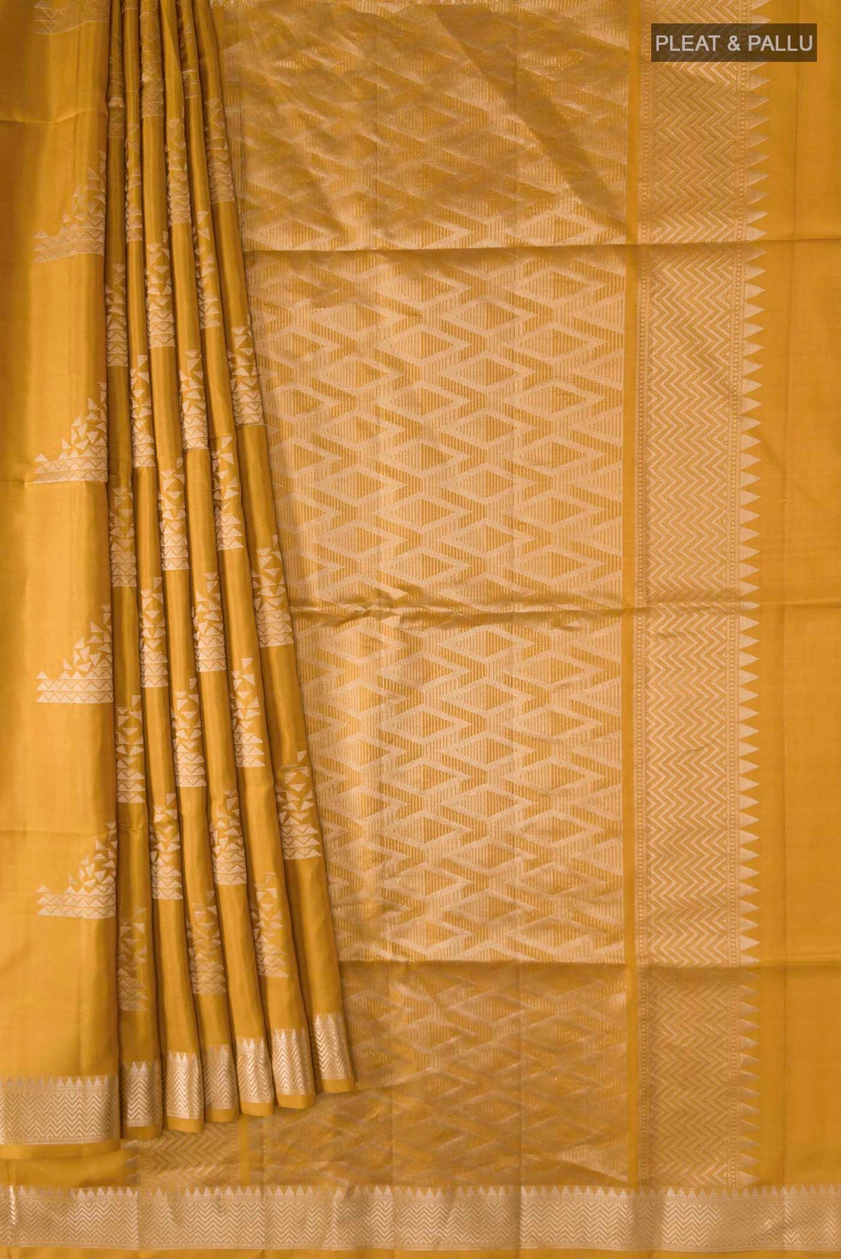 Pleats and pallu of Mustard Soft Silk Saree with Zari Butta on the body and Zari Border