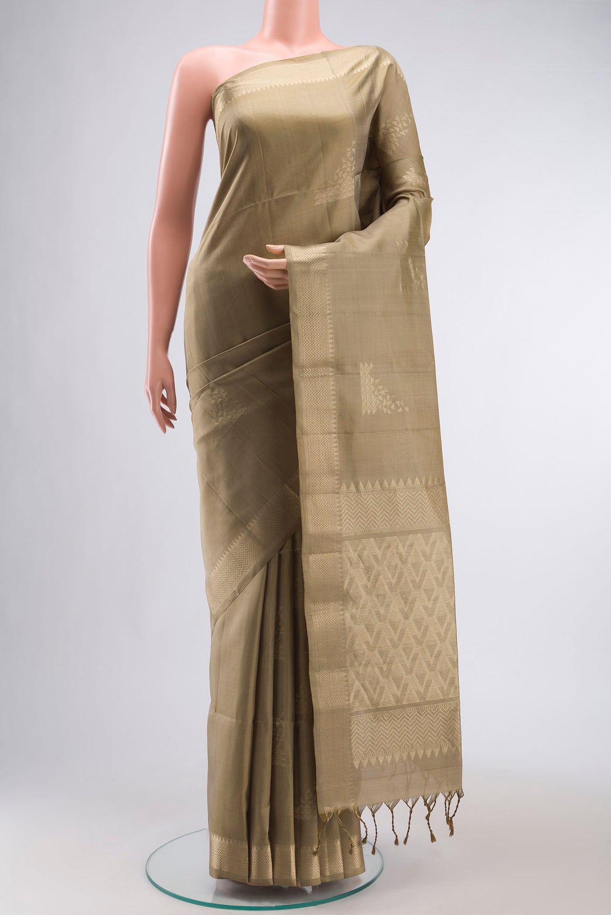 Beige Soft Silk Saree with Zari Butta on the body and Zari Border displayed on a mannequin