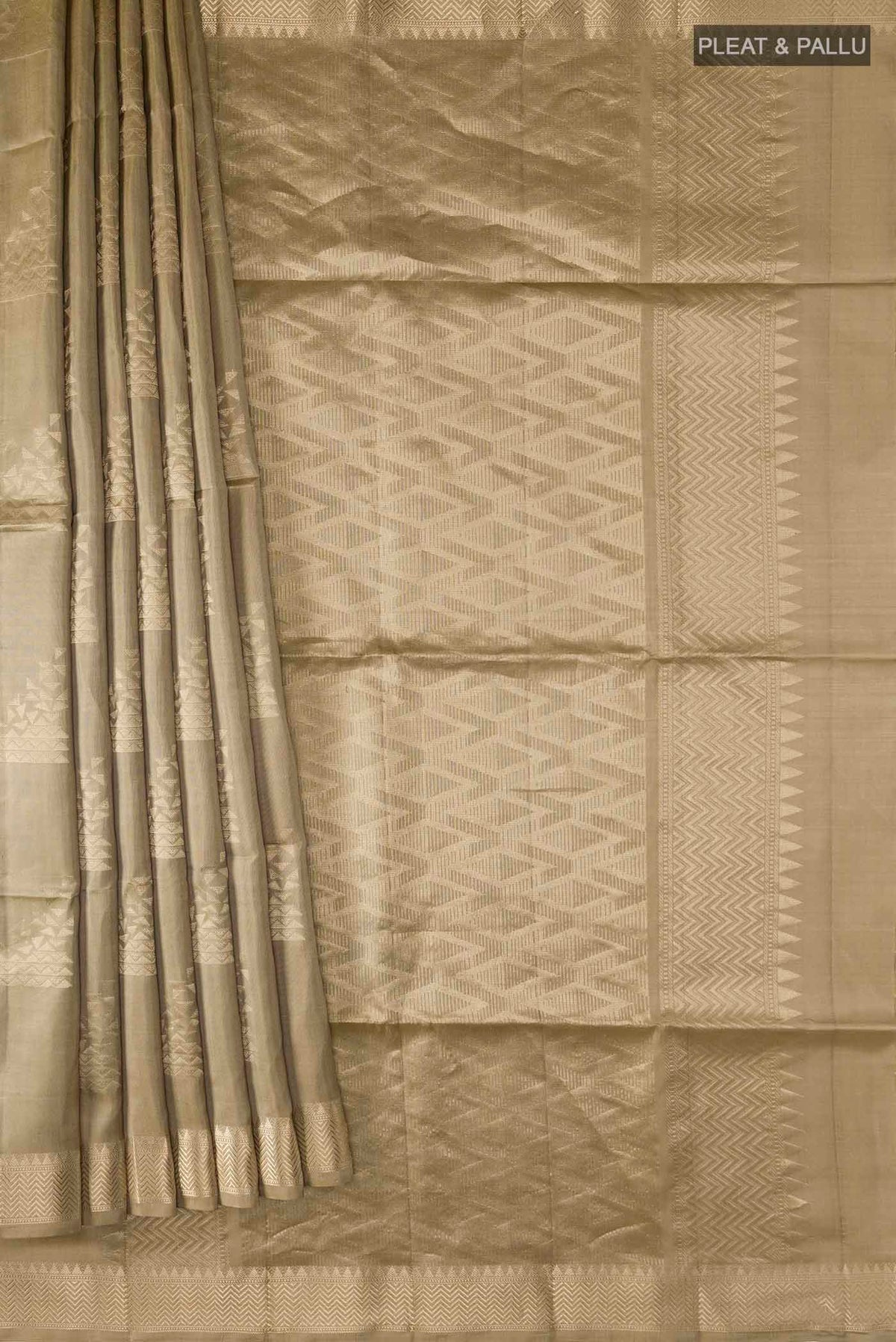 Pleats and pallu of Beige Soft Silk Saree with Zari Butta on the body and Zari Border