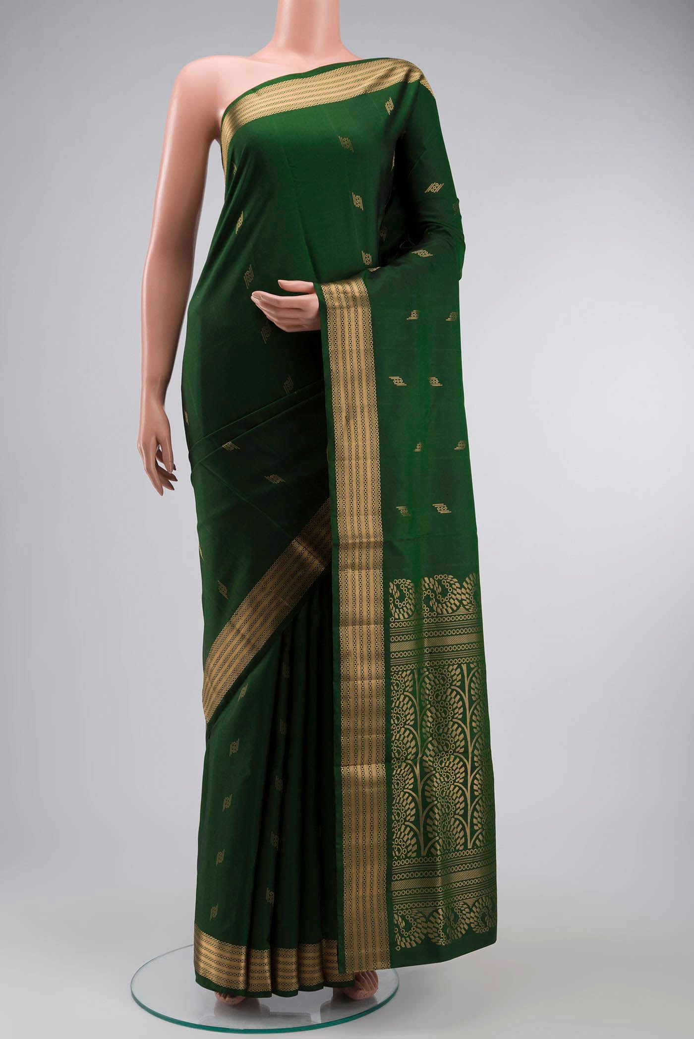 Green Soft Silk Saree with Zari Butta on the body and Zari Border displayed on a mannequin