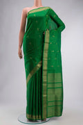 Green Soft Silk Saree with Zari Butta on the body and Zari Border displayed on a mannequin